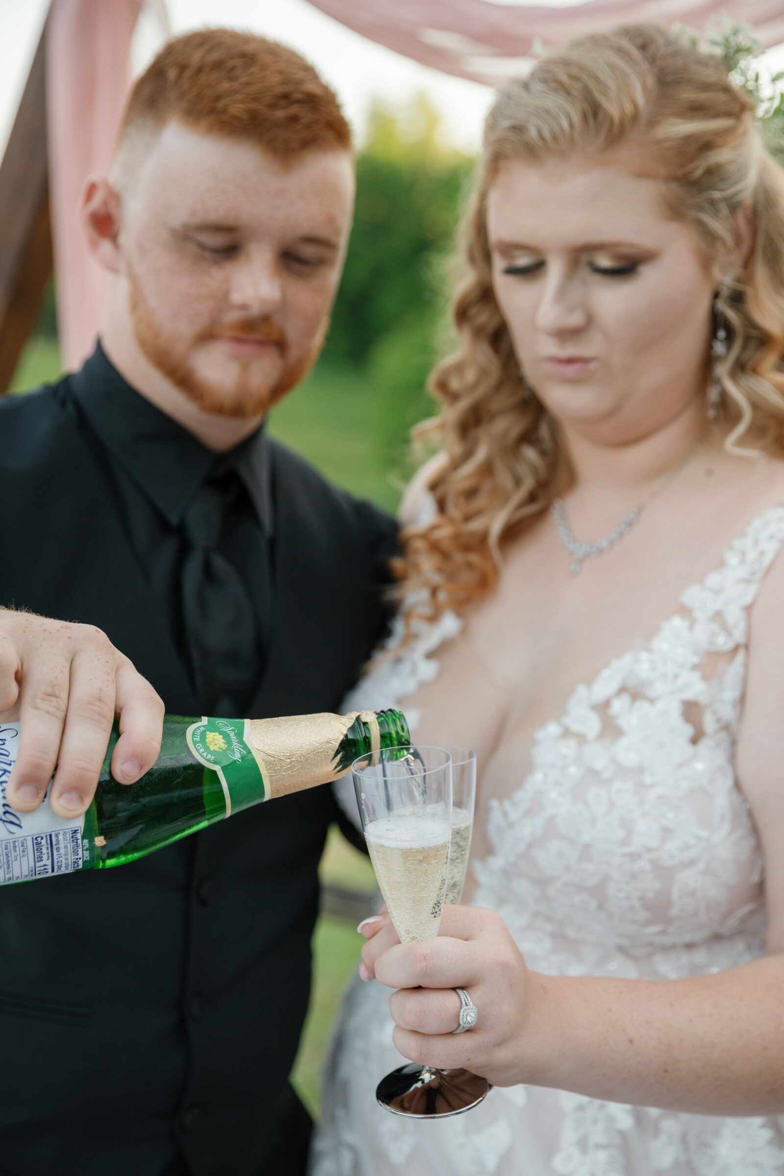 Full Bloom Farm Wedding | groom pours sparkling grape juice for bride