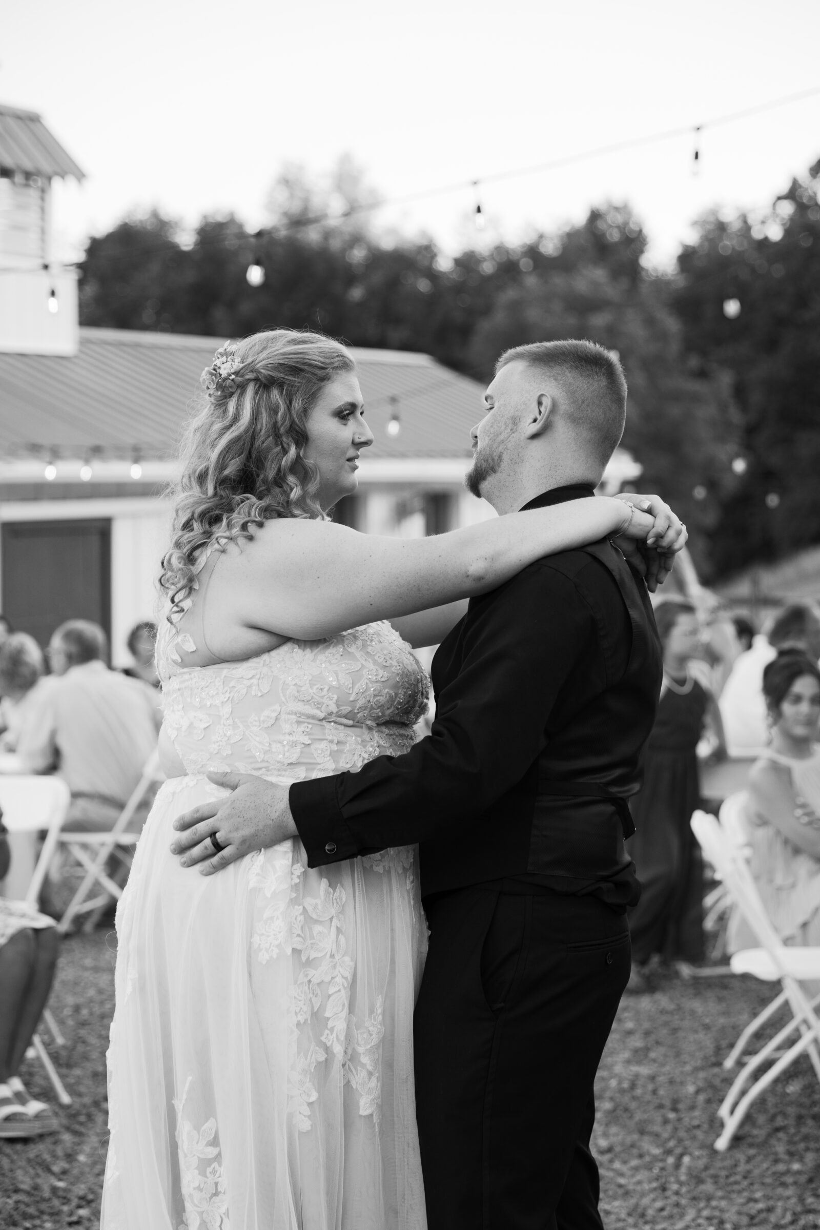 Full Bloom Farm Wedding | black and white image of bride and groom sharing a first dance outside