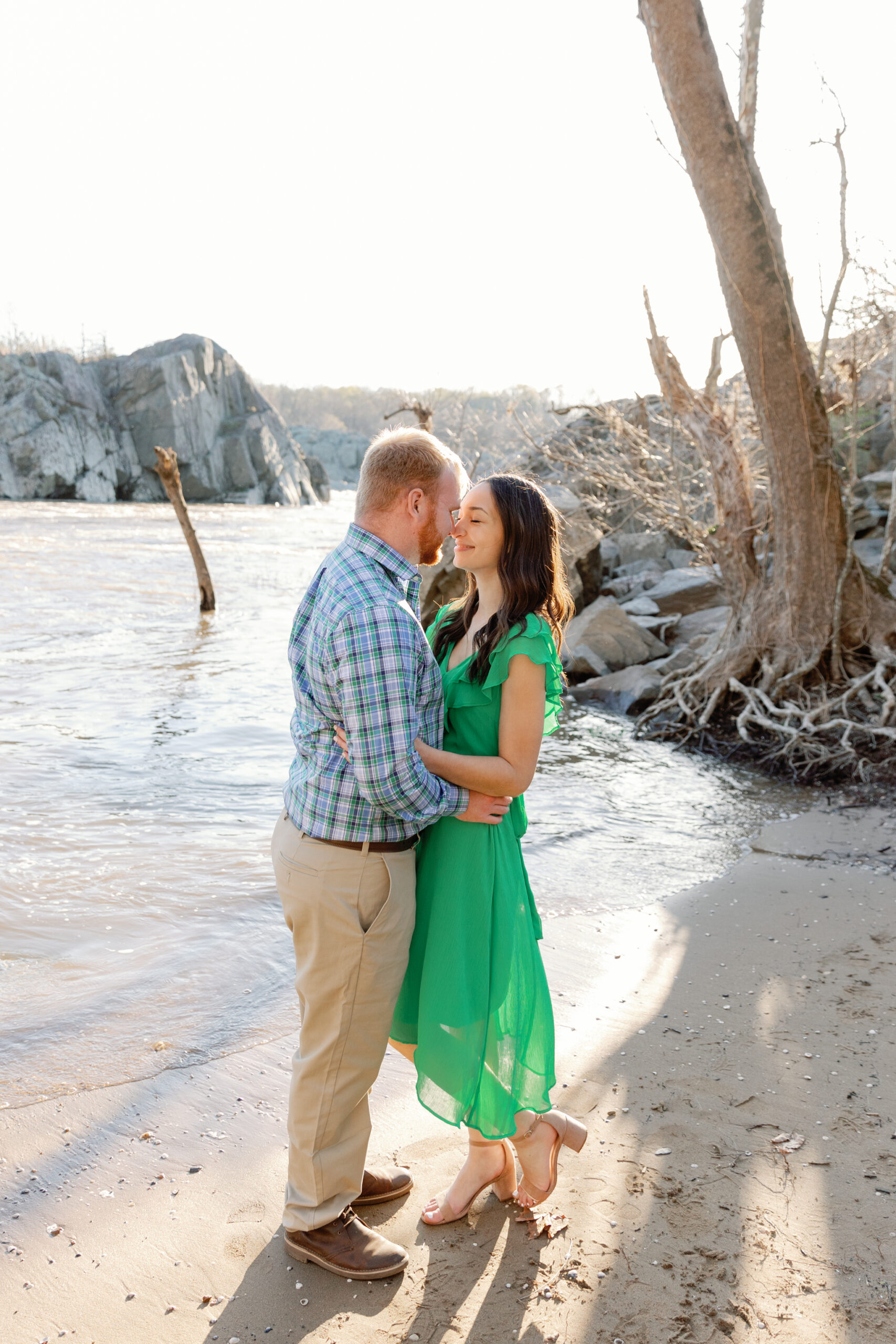 Engagement Session at Great Falls Park in Maryland | couple on a beach share a romantic moment