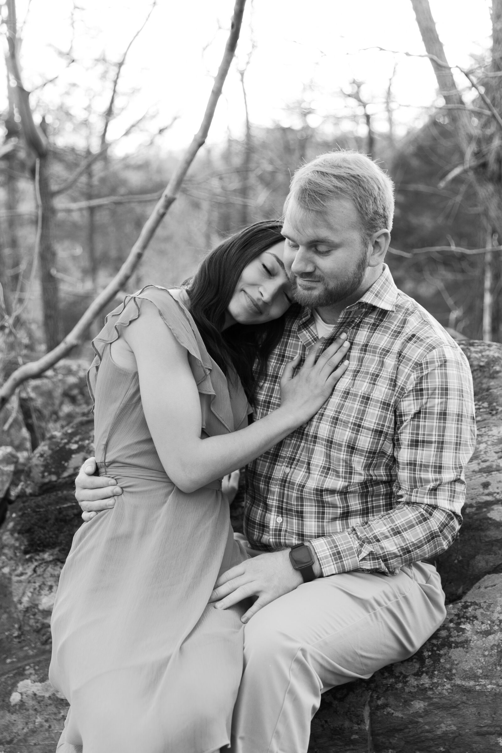 Engagement Session at Great Falls Park in Maryland | black and white image of a couple sitting on a rock