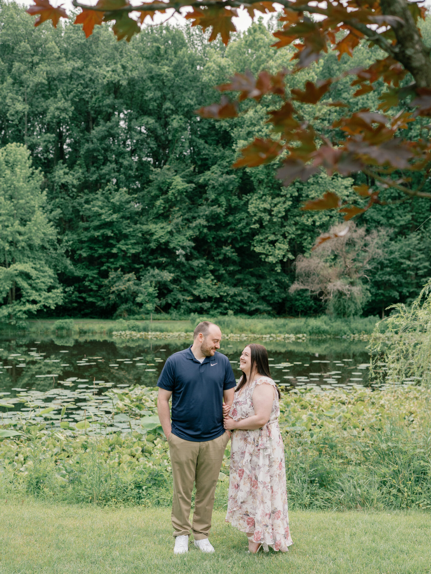 Meadowlark Botanical Gardens Engagement Session | couple stands arm in arm in front of a pond at Meadowlark Botanical Gardens in Vienna, VA