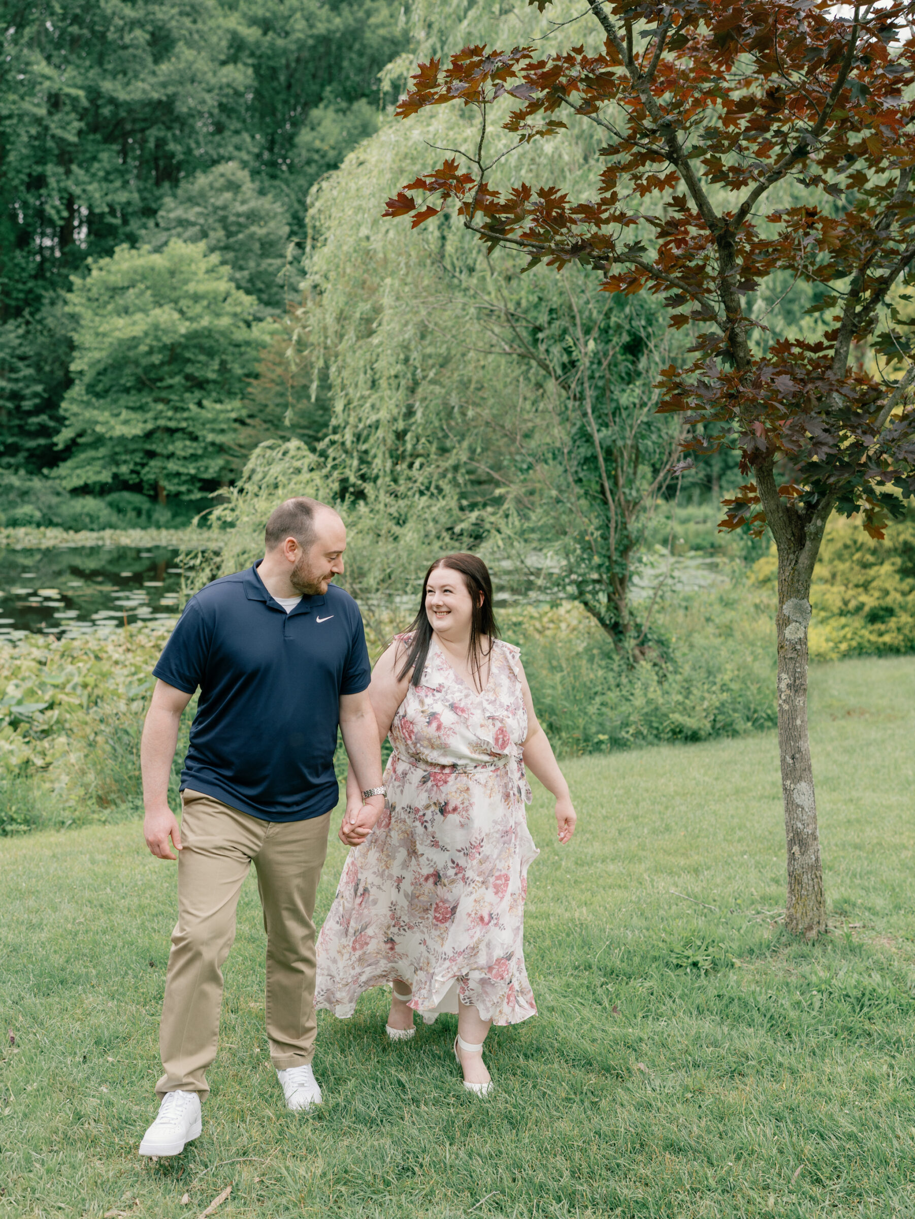 Meadowlark Botanical Gardens Engagement Session | newly engaged couple walk hand in hand in front of a pond at Meadowlark Botanical Gardens in Northern Virginia