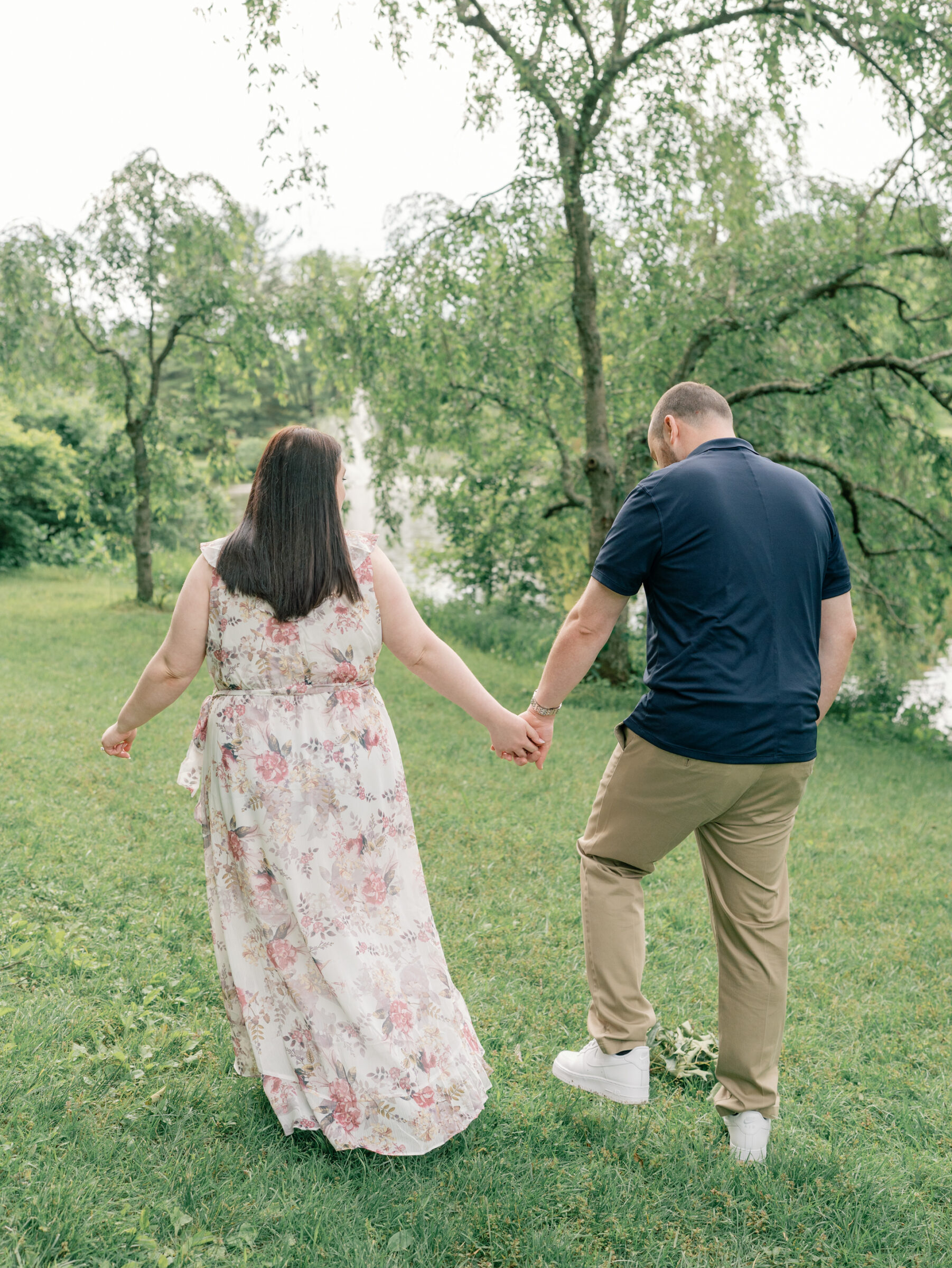 Meadowlark Botanical Gardens Engagement Session | couple walking towards pond, away from camera