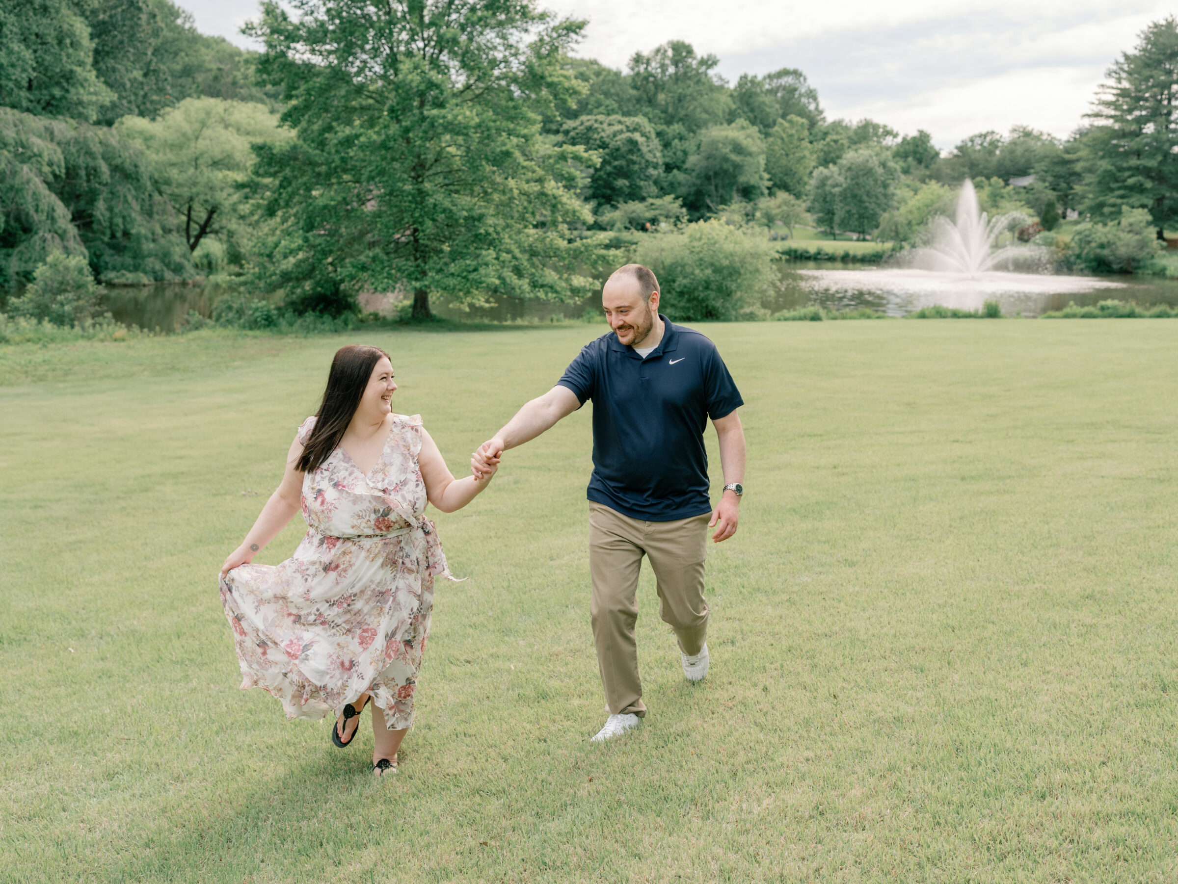 Meadowlark Botanical Gardens Engagement Photos | couple runs hand in hand at a Northern Virginia botanical garden