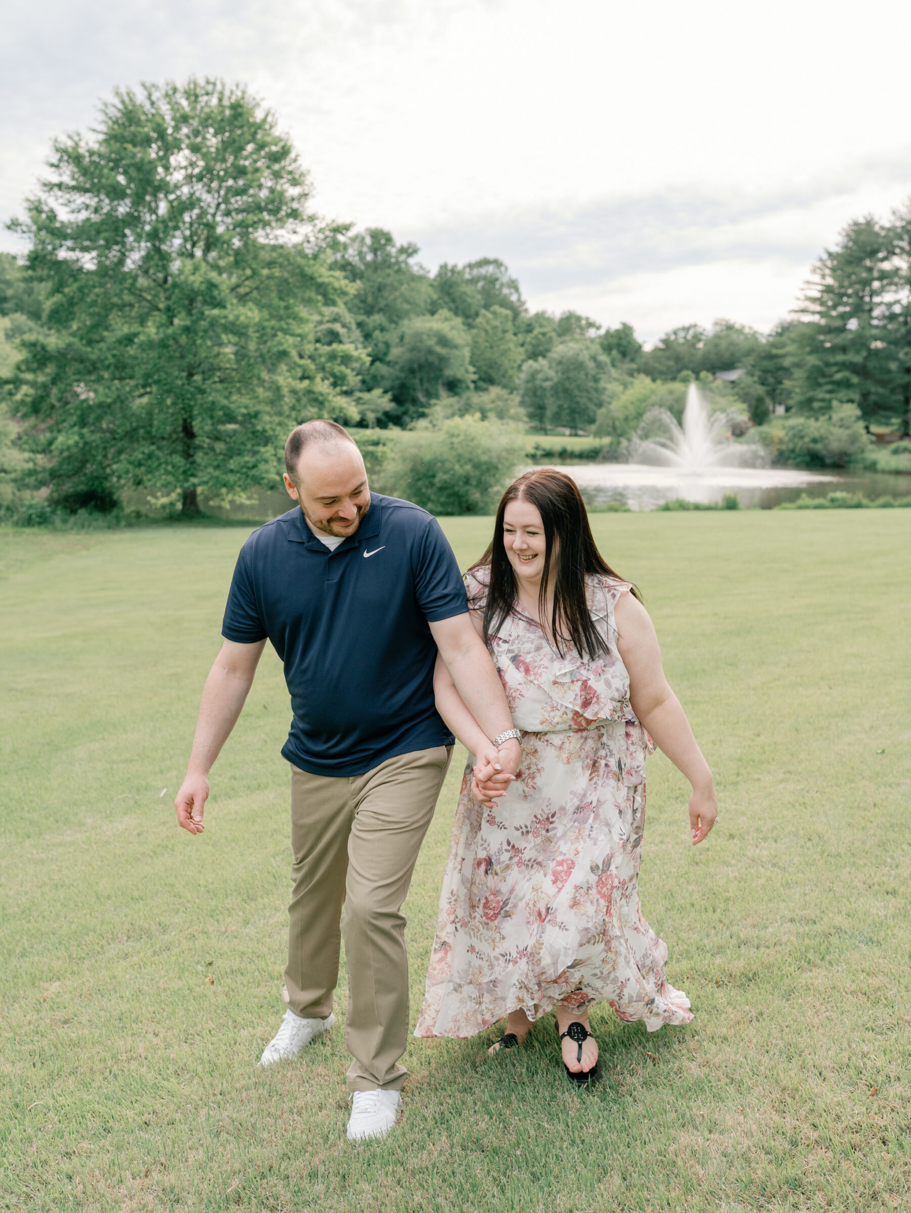Meadowlark Botanical Gardens Engagement Photos | couple bumps into each other while they walk in Meadowlark Botanical Gardens in Northern VA