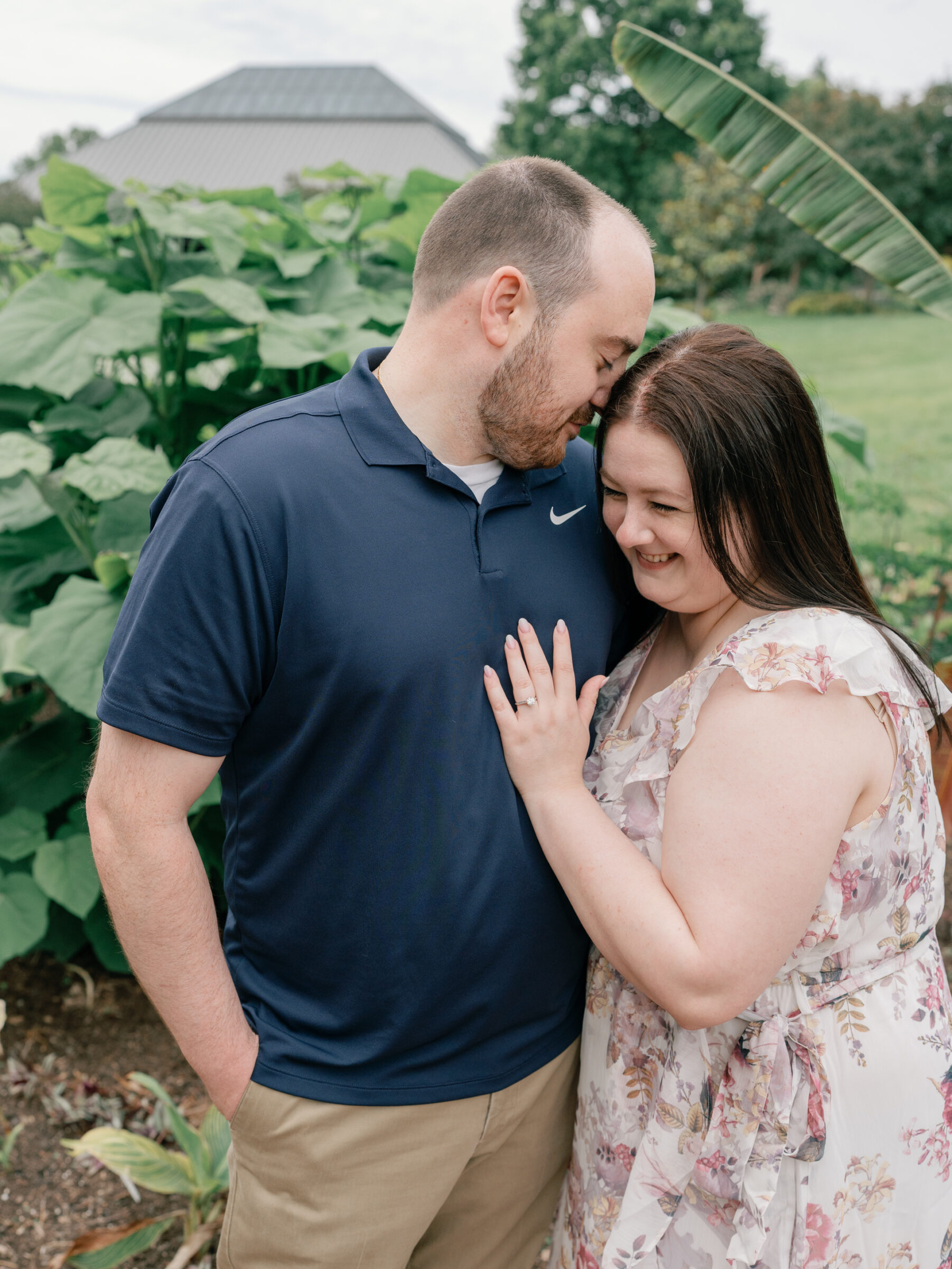 Meadowlark Botanical Gardens Engagement Session | groom in navy blue polo nuzzles into his bride-to-be