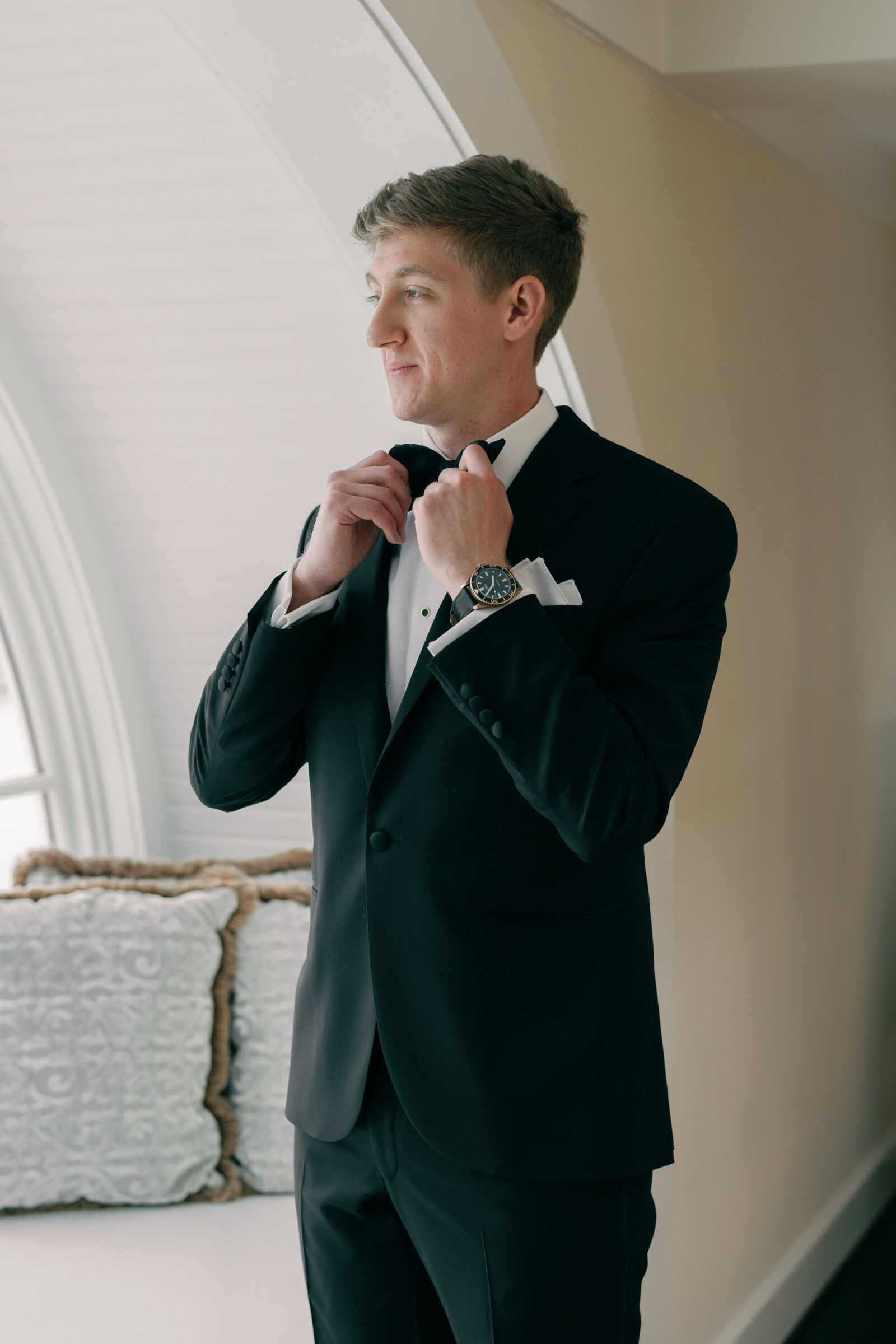 Charlottesville VA Wedding Photographer | groom puts on bow tie at Trump Winery