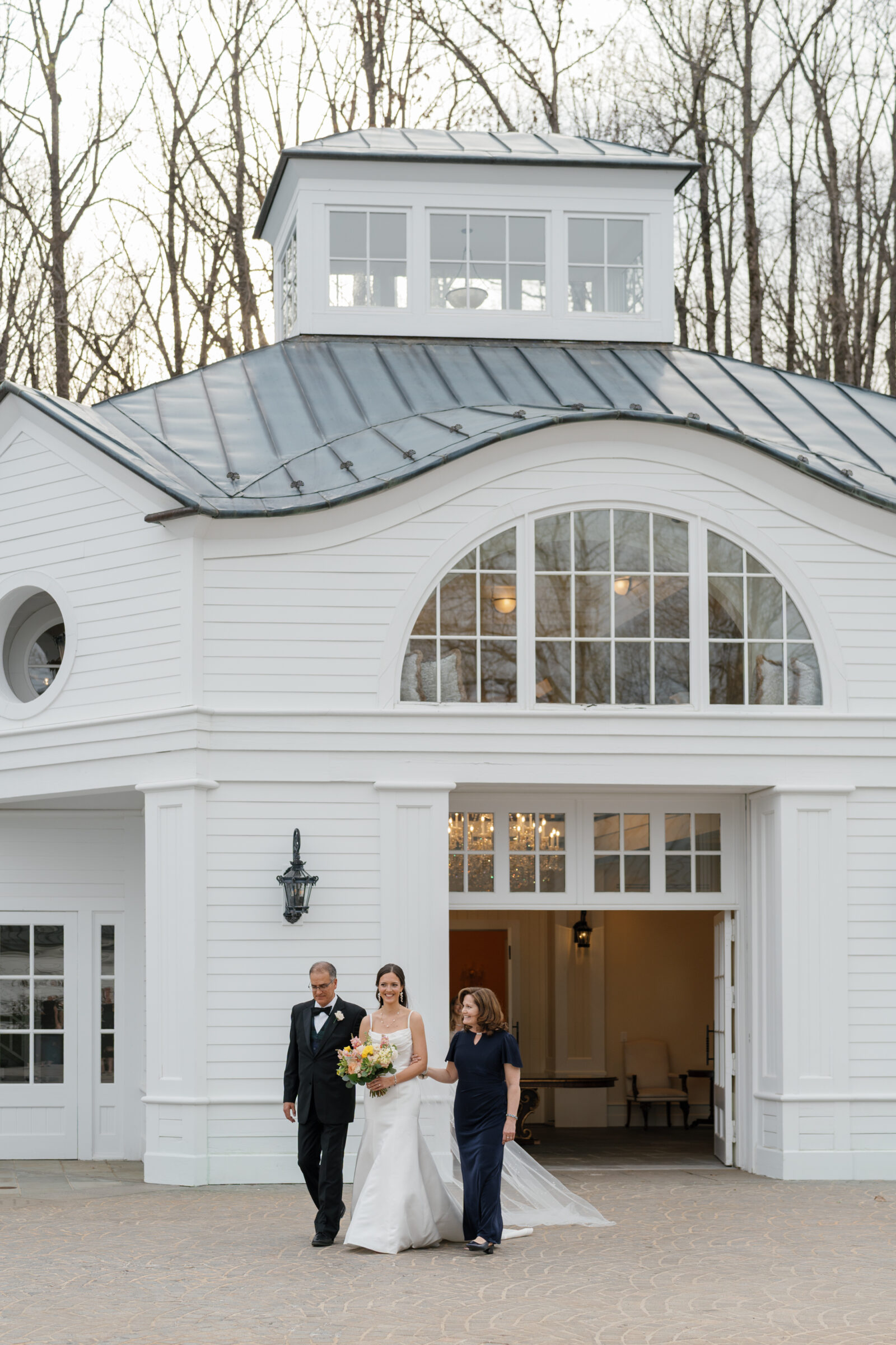 Wedding at Trump Winery Grand Hall | bride and parents walking to ceremony
