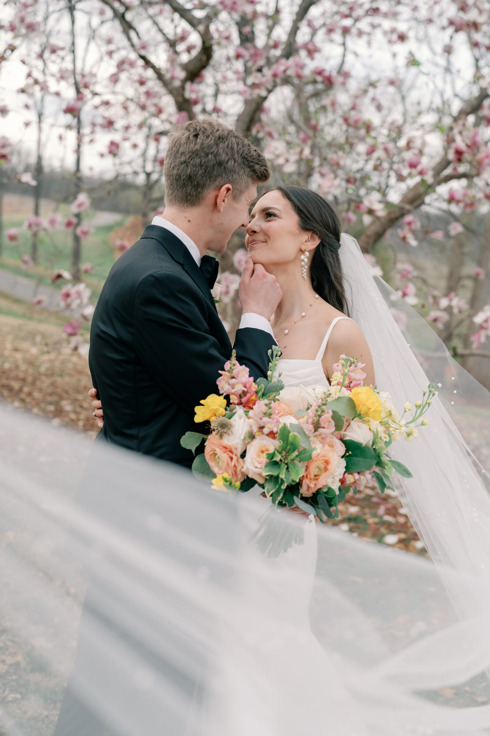 Wedding at Trump Winery in Charlottesville VA | groom holds bride's chin romantically as they look at each other