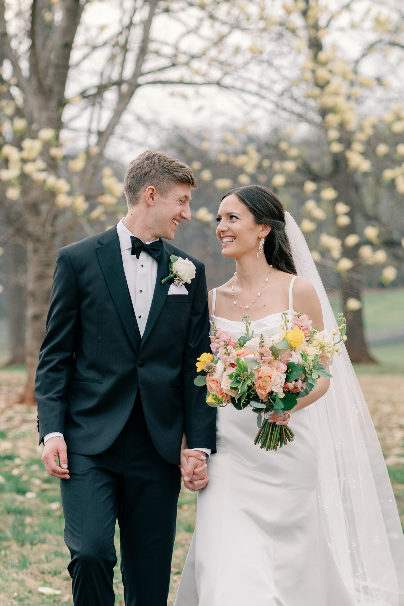 Wedding at Trump Winery in Charlottesville VA | bride and groom smile at each other as they walk