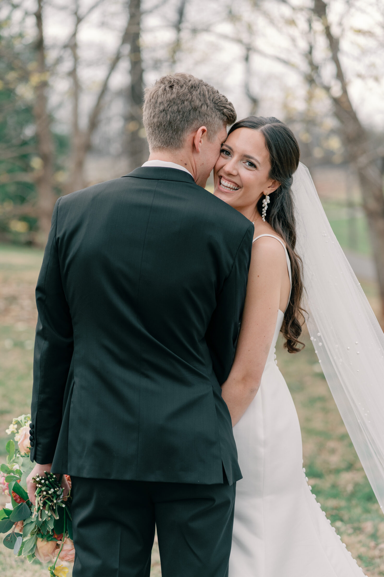 Wedding at Trump Winery in Charlottesville VA | groom kisses bride on cheek