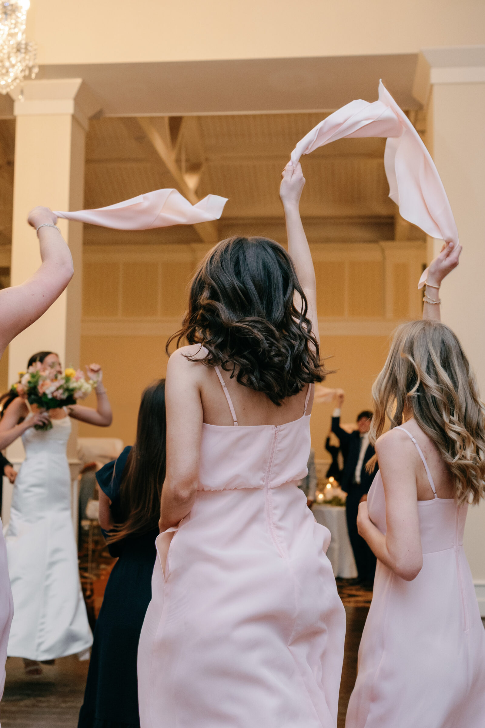 Trump Winery Wedding in Charlottesville | wedding guests wave pink napkins in the air to welcome bride and groom into reception