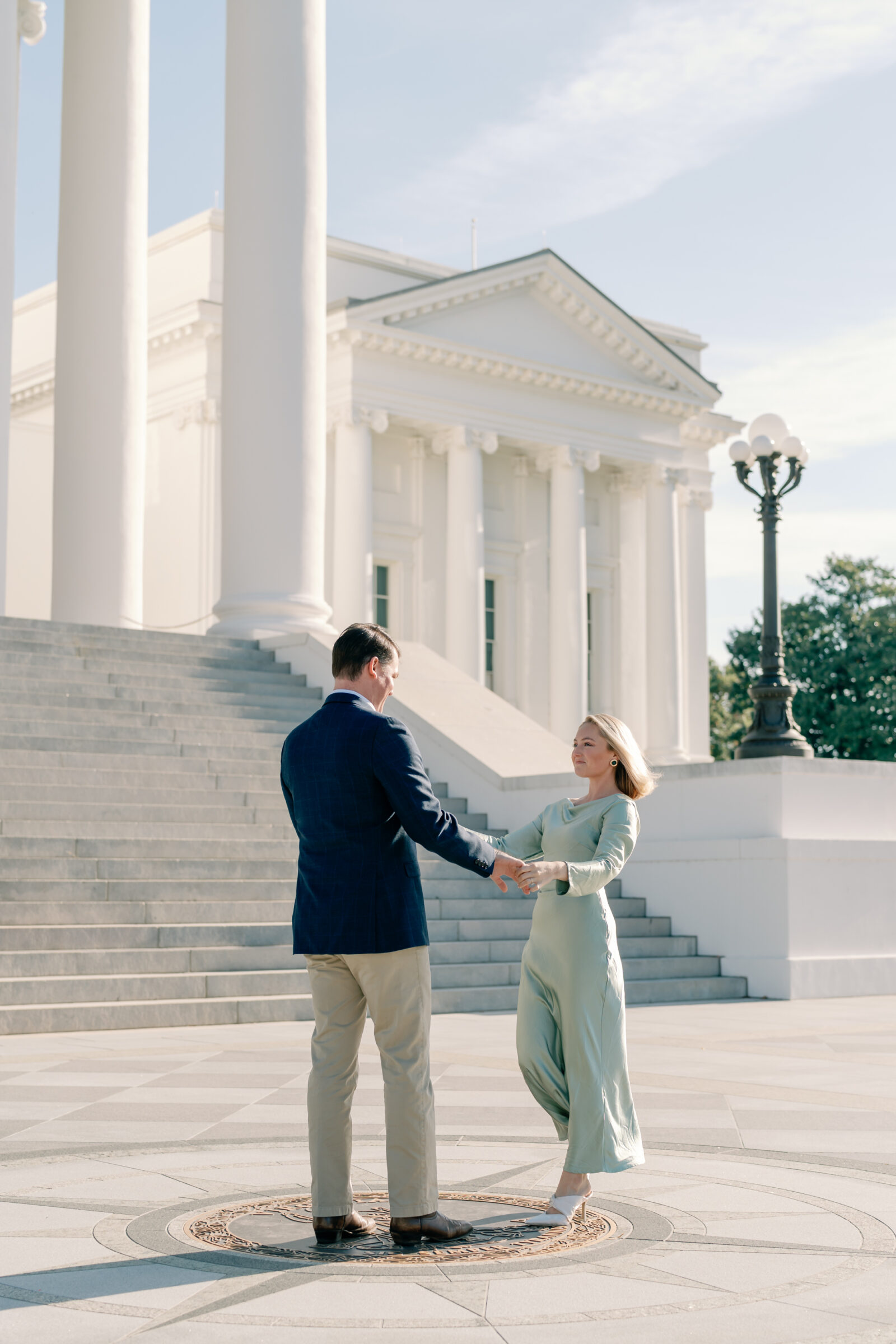 Engagement Photos at the Virginia Capitol Building | Engagement Photographer in Richmond VA | engaged couple dancing in front of the steps of the Virginia Capitol Building in downtown Richmond VA