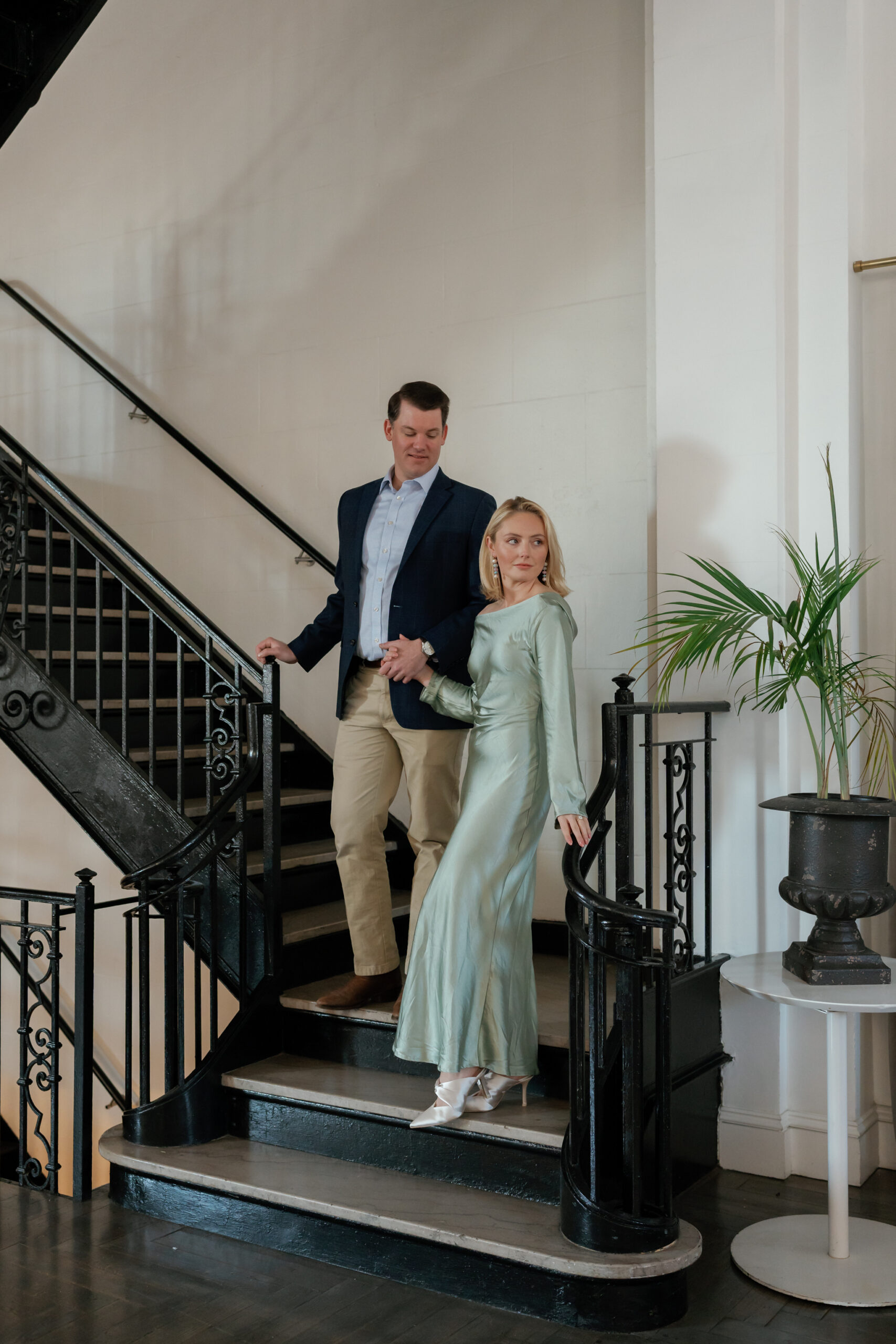 Engagement Photographer Richmond VA | couple on the grand, black wrought iron at the Quirk Hotel RVA