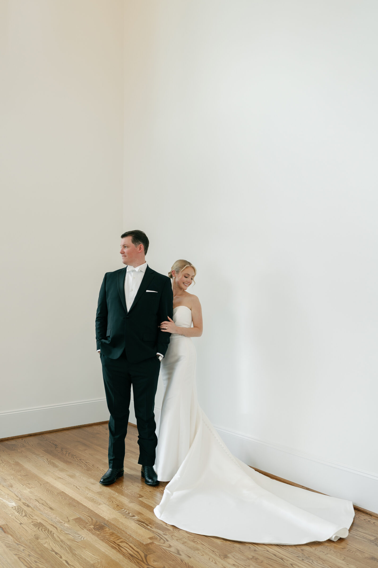 Bride and groom share a quiet first look moment inside Northfield Estate in Cumberland, VA, standing in a light-filled corner with white walls and hardwood floors—an elegant and intimate pre-ceremony portrait near Richmond.