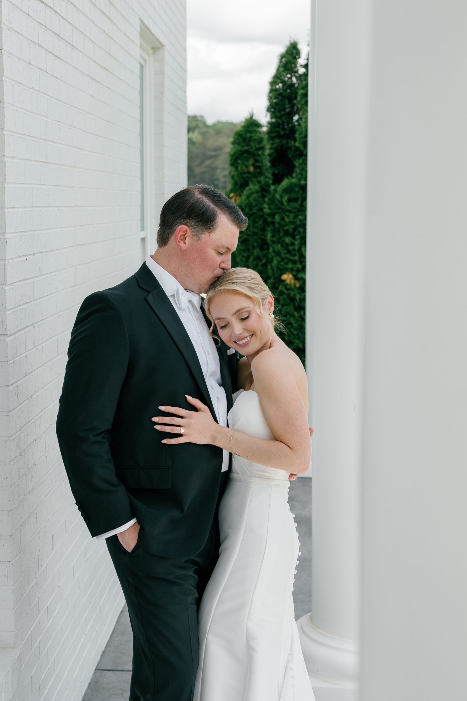 Bride and groom sharing a quiet moment on the columned front porch of Northfield Estate in Cumberland, VA—an intimate and elegant wedding day portrait at this timeless Virginia venue near Richmond.