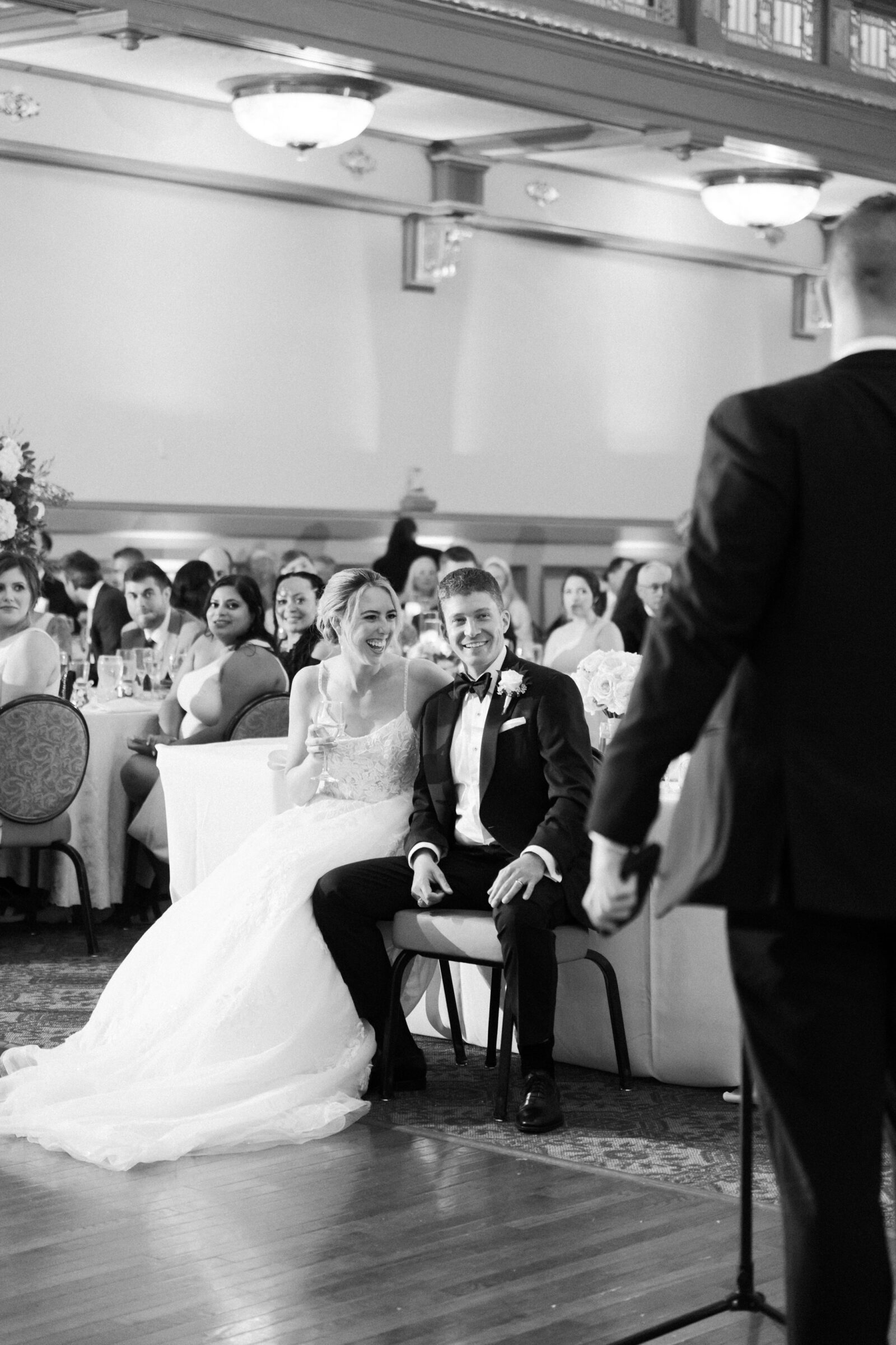 Bride and groom laughing together during wedding toasts in Richmond VA.