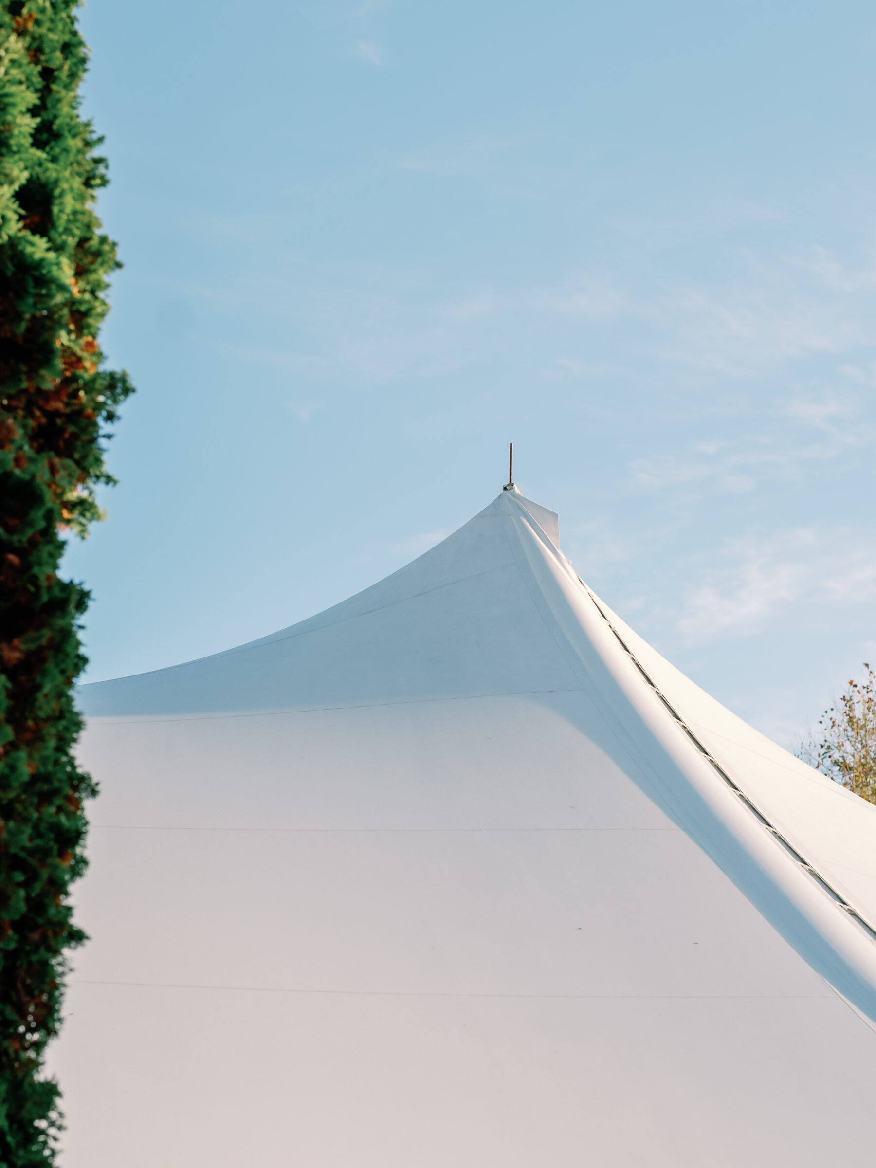 European Gallery Tent in Richmond VA, elegant white tent wedding reception space against a blue sky