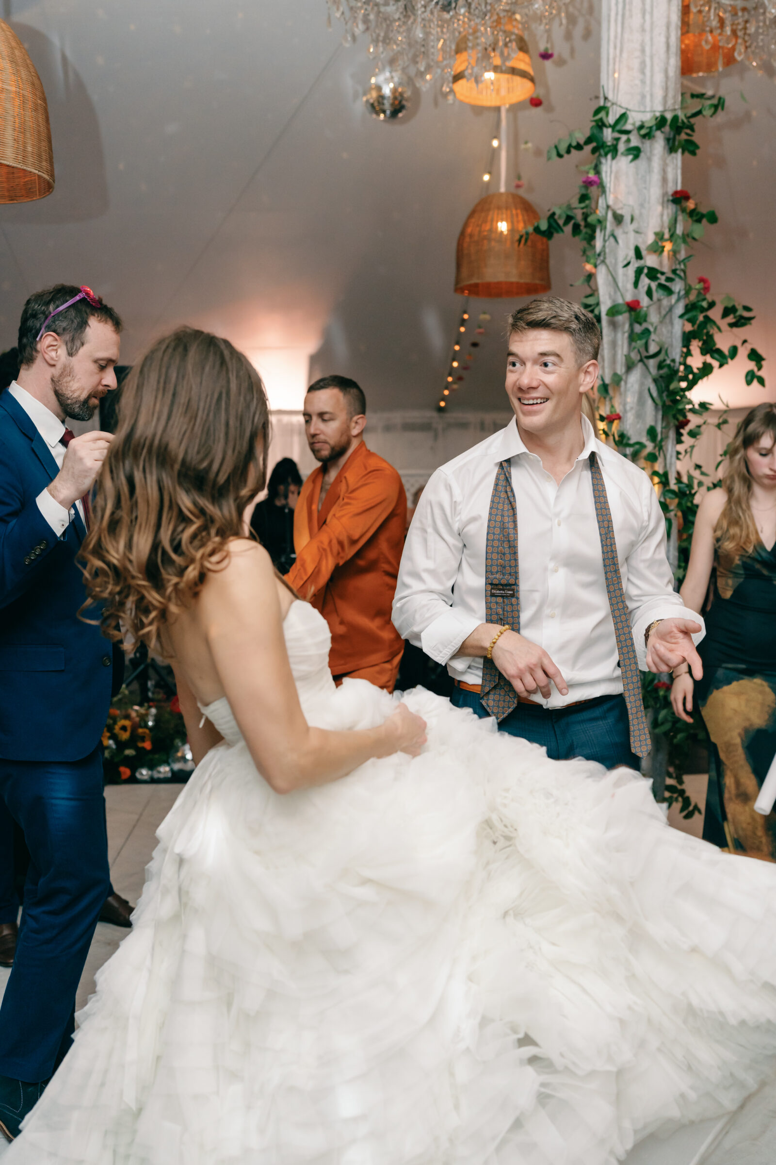 Bride and groom laughing and dancing during their Mankin Mansion wedding reception in Richmond VA, surrounded by guests on the dance floor.