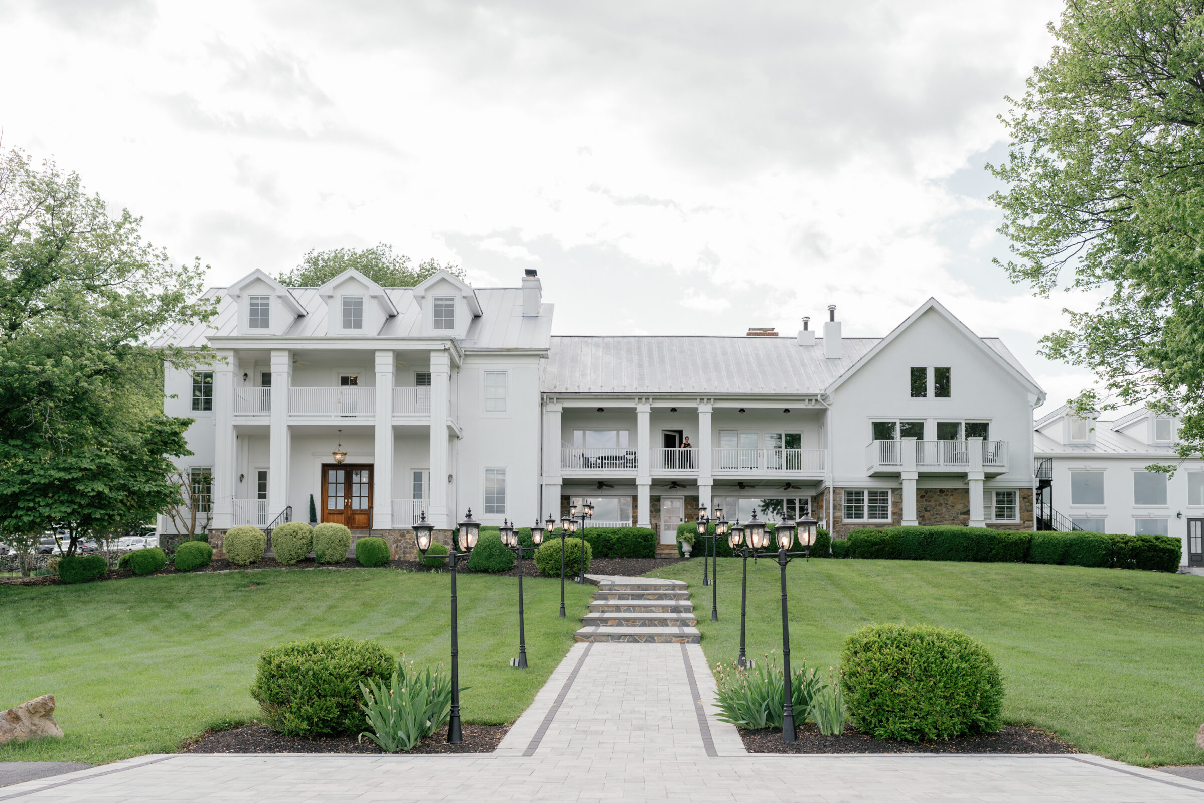 The View at Bluemont, a luxury Northern VA wedding venue with elegant white estate architecture, mountain views, and outdoor ceremony and reception spaces.