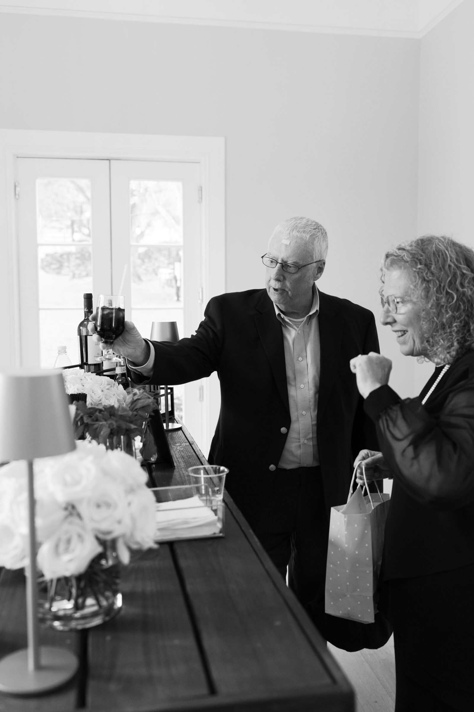 Guests enjoying drinks at the indoor bar during cocktail hour at a Northern Virginia wedding venue.