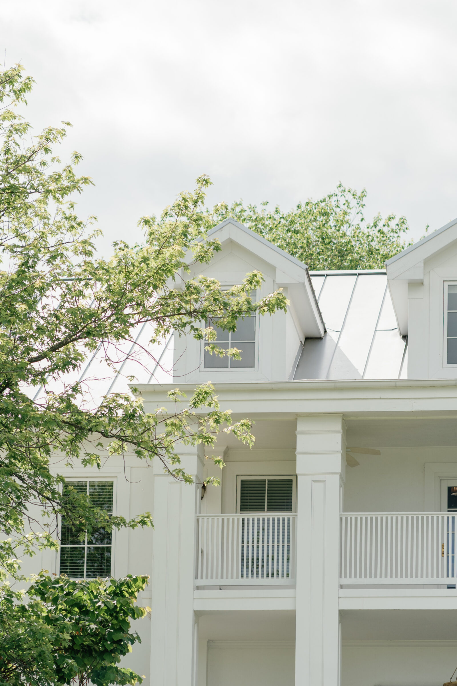 Detail view of The View at Bluemont’s white columned balcony and windows, a romantic Northern Virginia wedding venue.