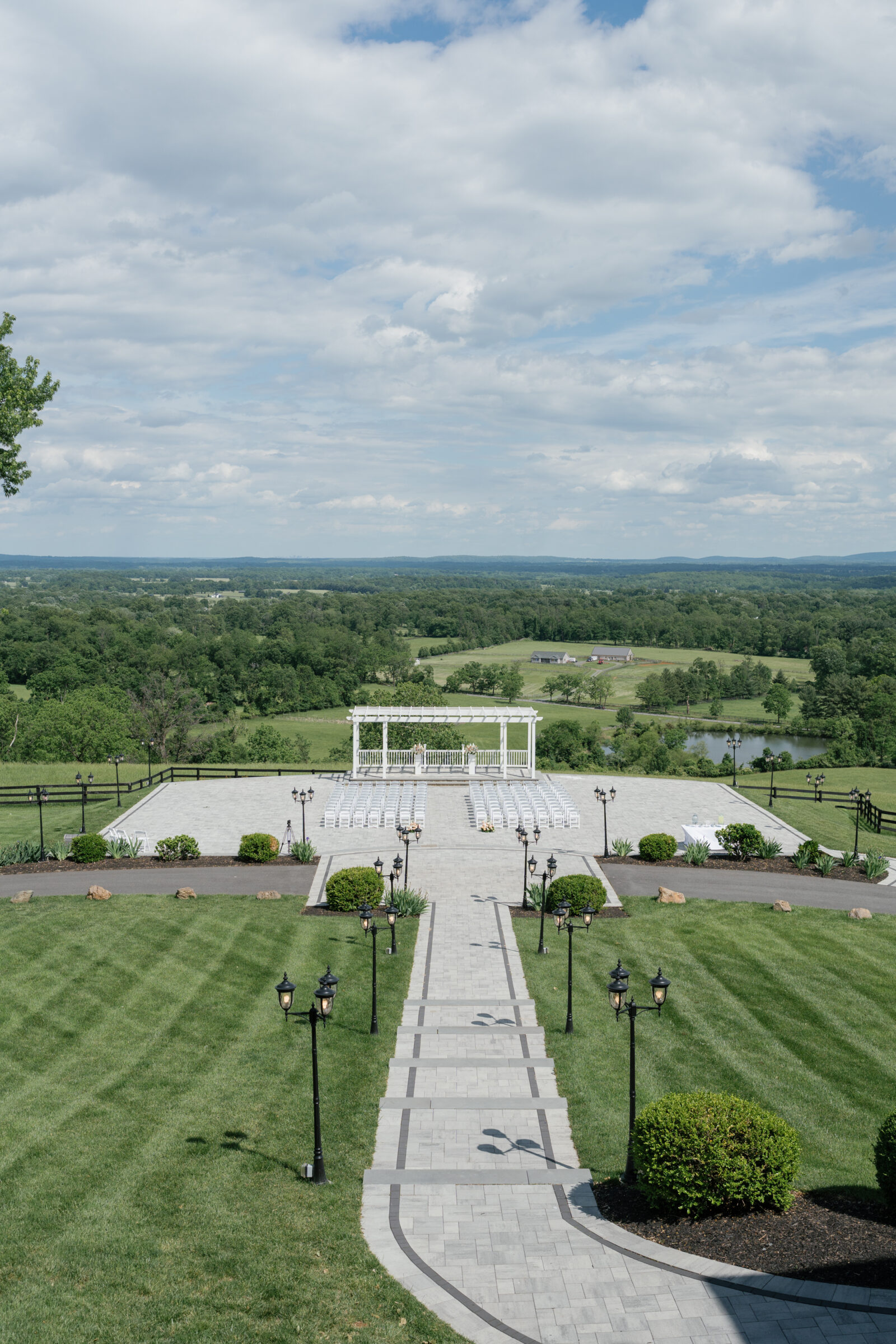 Ceremony space on the Grand Patio at The View at Bluemont wedding venue with sweeping Blue Ridge Mountain views and elegant white pergola setup.