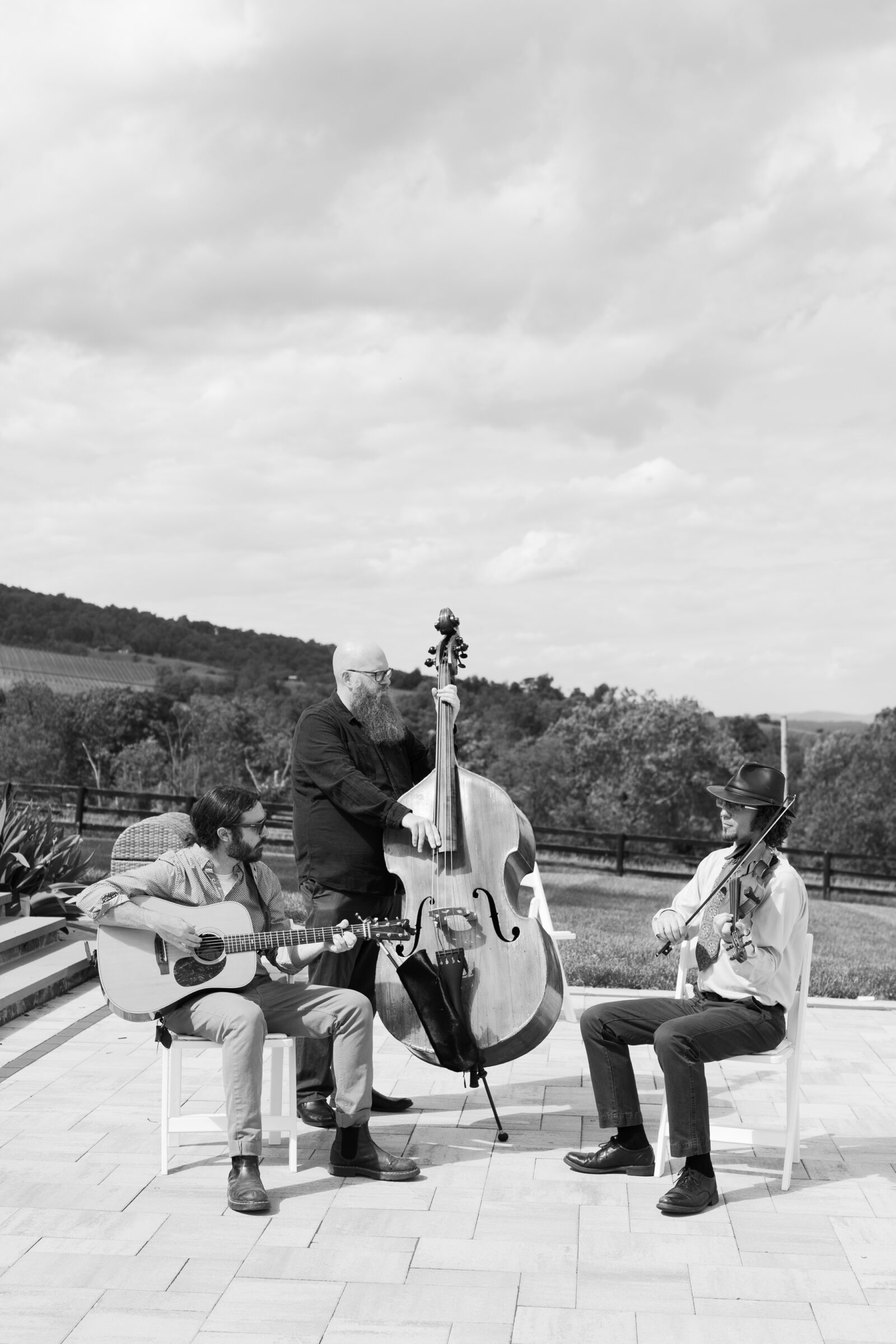 Live musicians playing guitar, upright bass, and violin during a wedding ceremony in Northern VA.
