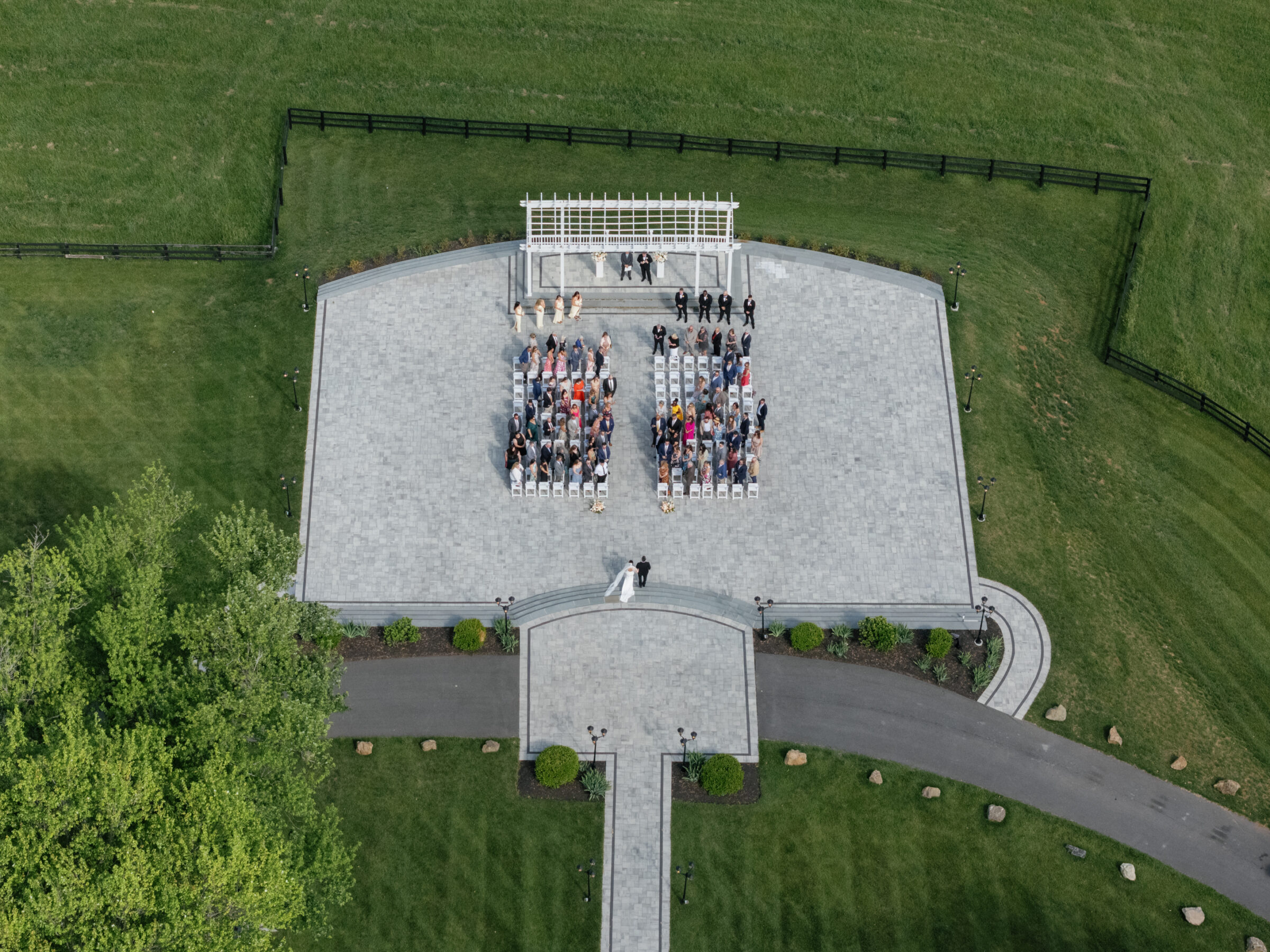 Aerial view of a Grand Patio ceremony at The View at Bluemont with guests seated around a white pergola, captured at a Northern VA wedding venue.