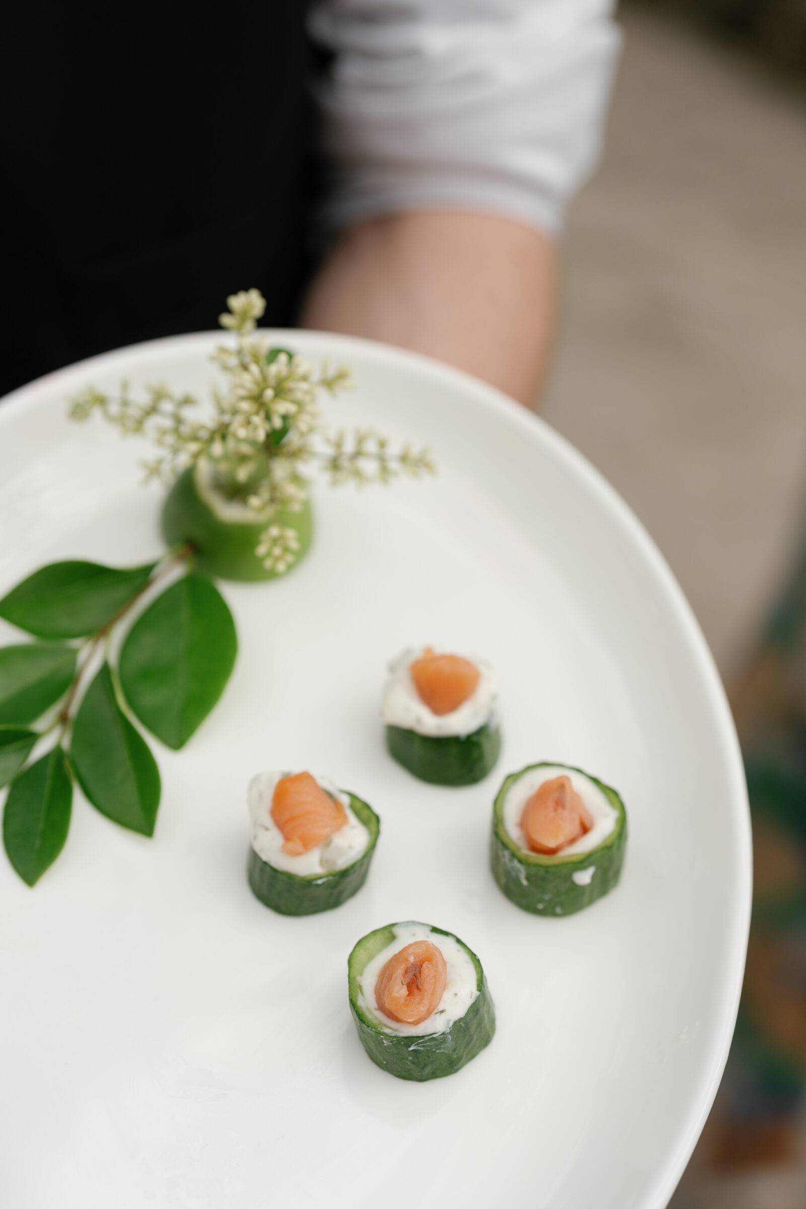 Elegant cucumber bites topped with smoked salmon and herbed cream cheese served during cocktail hour