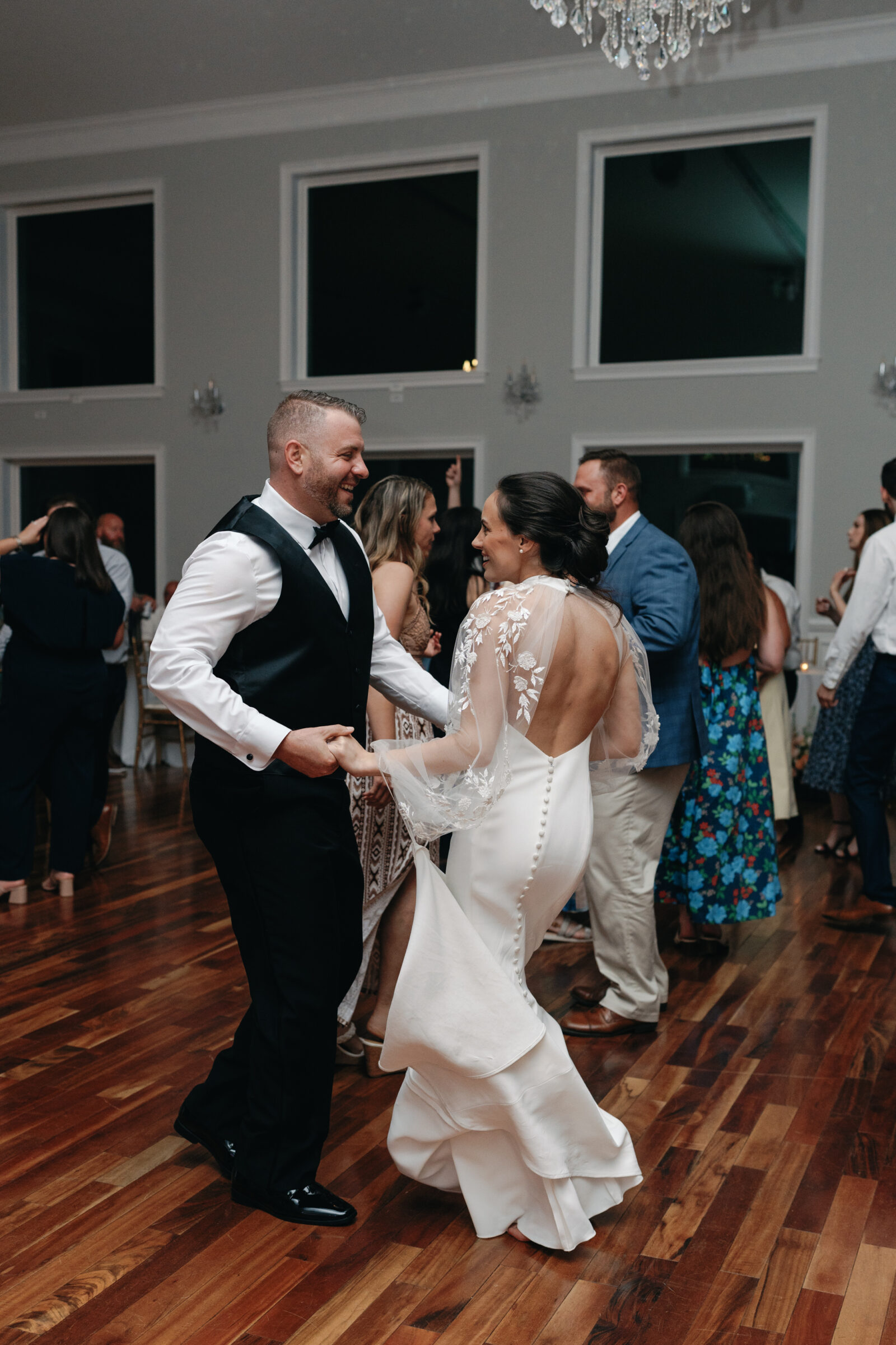 Bride and groom laugh together while dancing at their lively wedding reception at The View at Bluemont, a popular Northern Virginia wedding venue with elegant ballroom space.