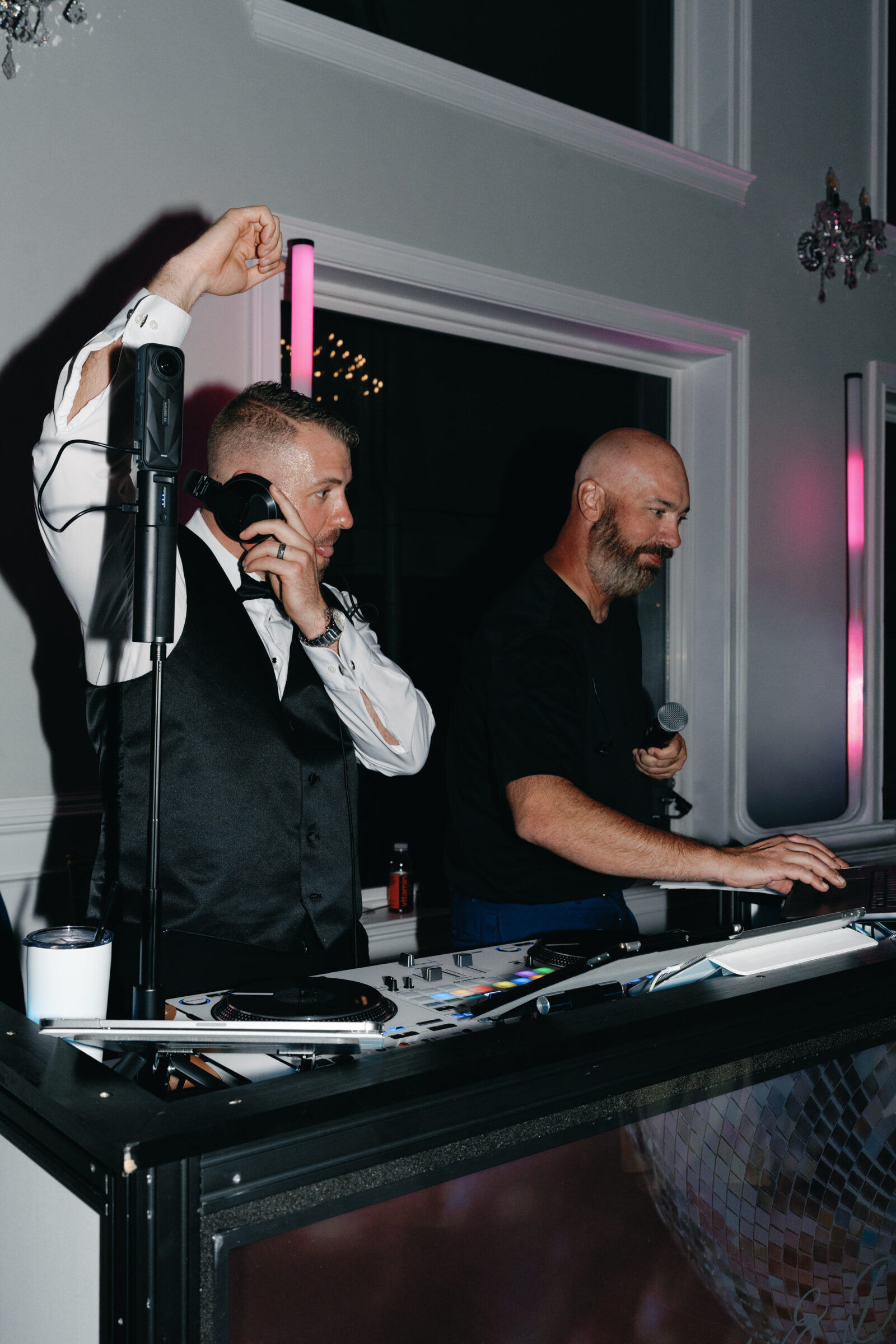 Groom joins the DJ booth during the wedding reception at The View at Bluemont, adding a lively and personal touch to the dance floor celebration.