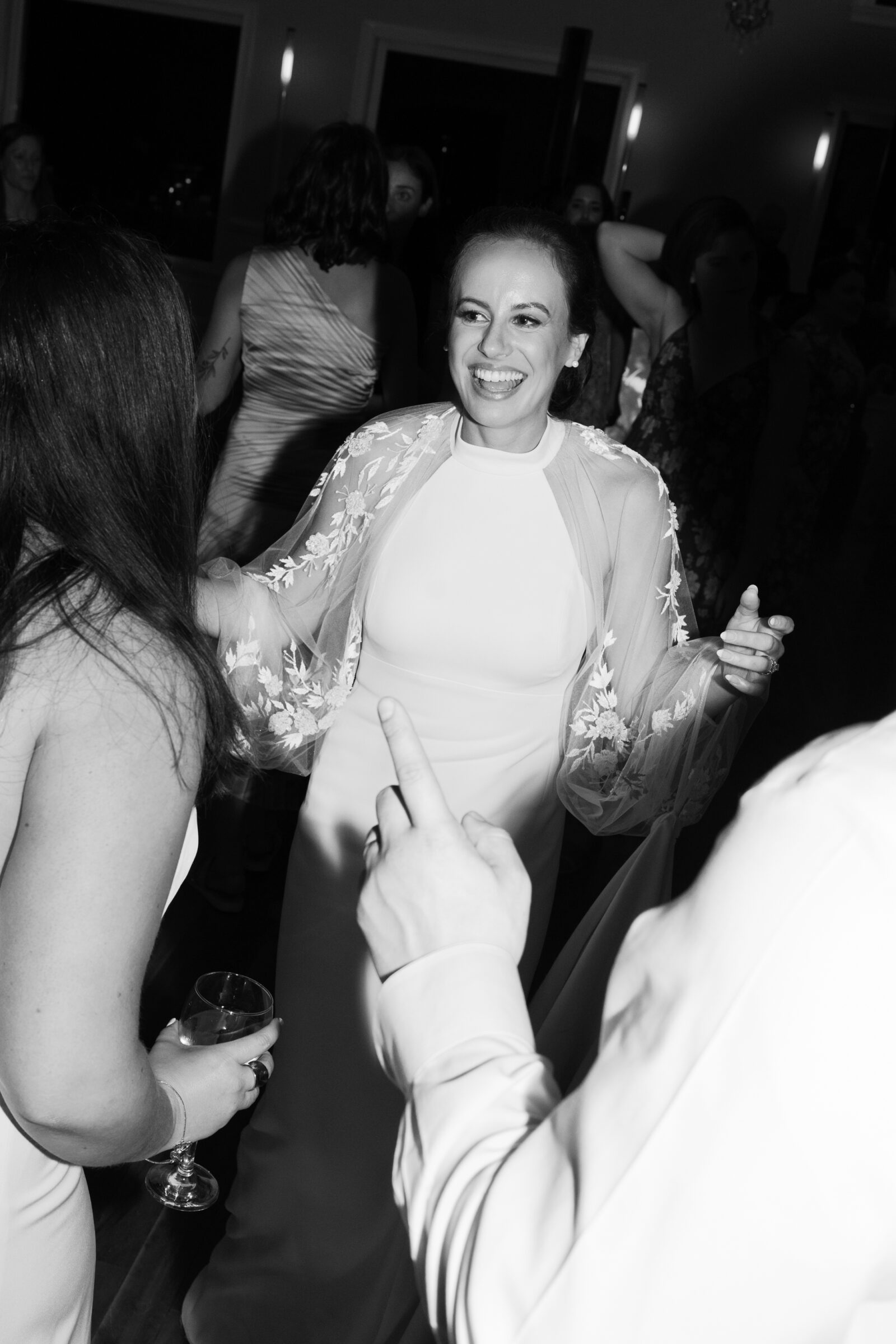 Bride laughing and dancing with guests during the wedding reception at The View at Bluemont, a lively Northern Virginia wedding venue.