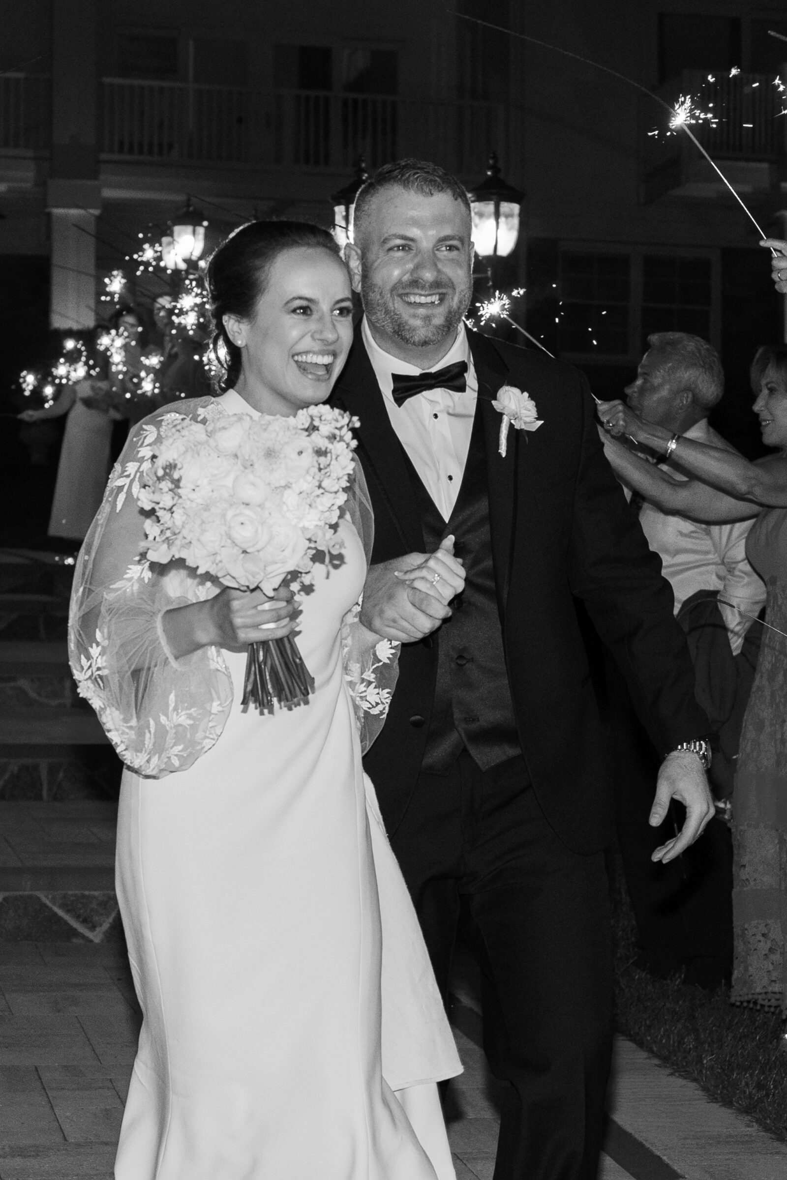 Bride and groom smiling during a sparkler exit at The View at Bluemont, a romantic Northern Virginia wedding venue.