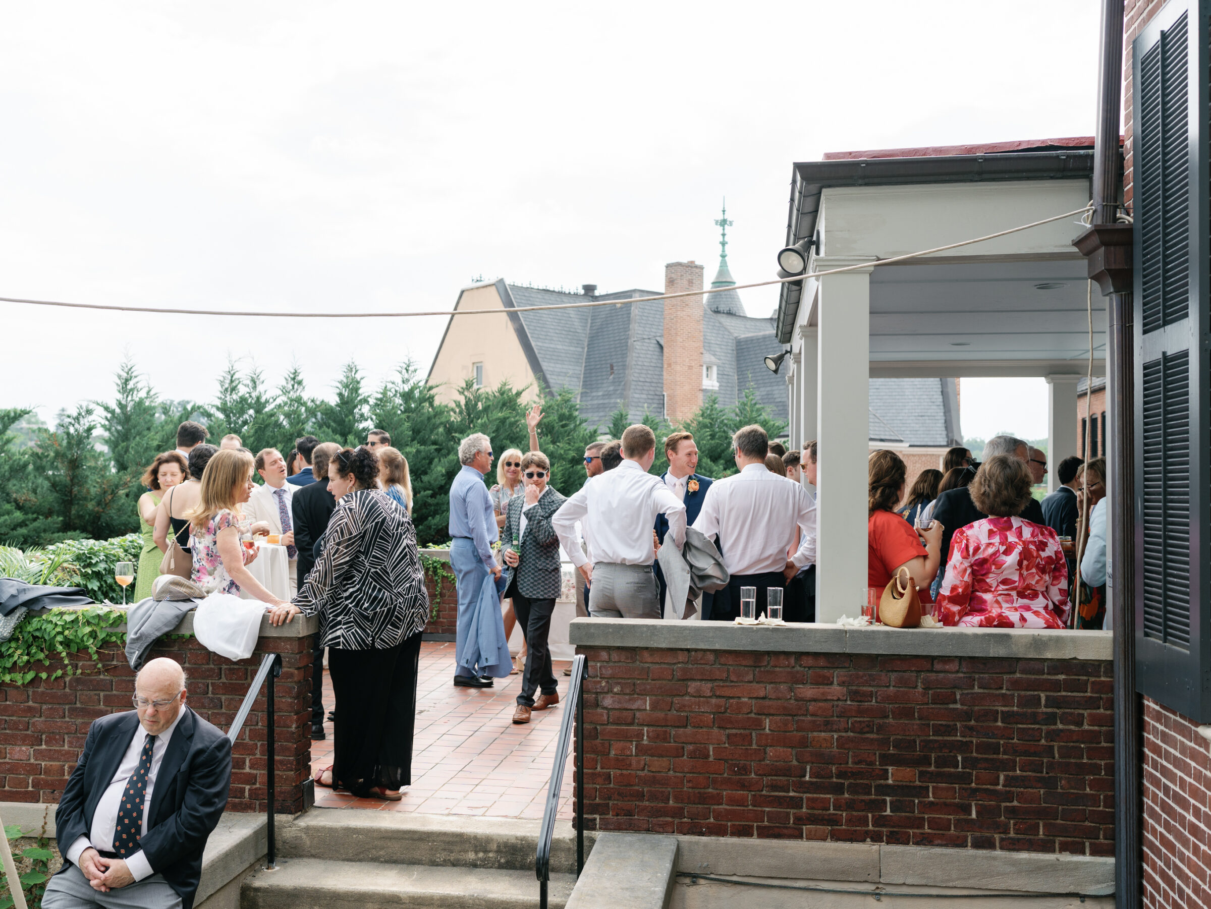 Guests mingling during an outdoor cocktail hour on the terrace of the Woodrow Wilson House Wedding venue in Washington DC.