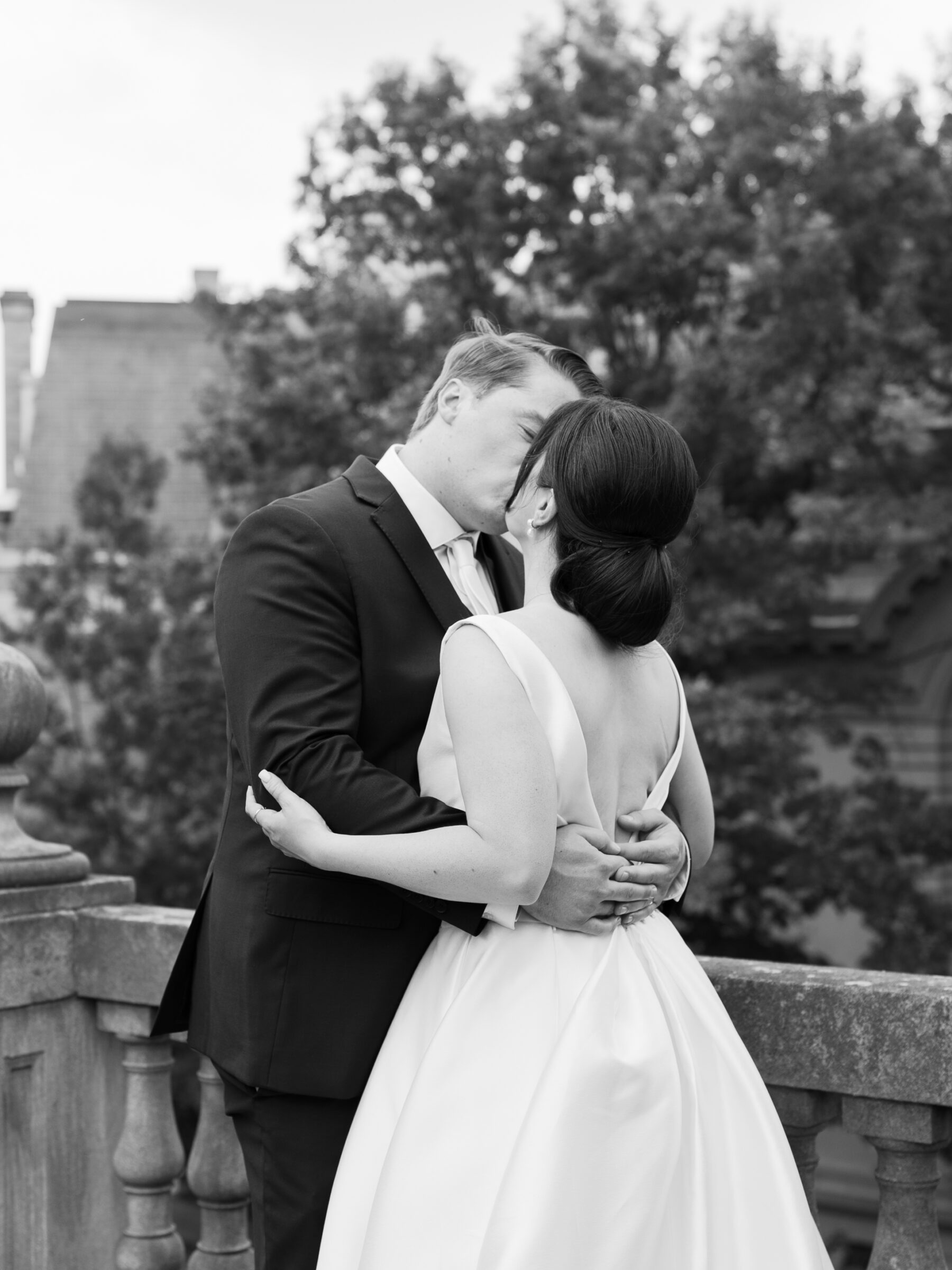 Romantic black and white portrait of the couple kissing on the terrace at a Woodrow Wilson House Wedding in Washington DC.