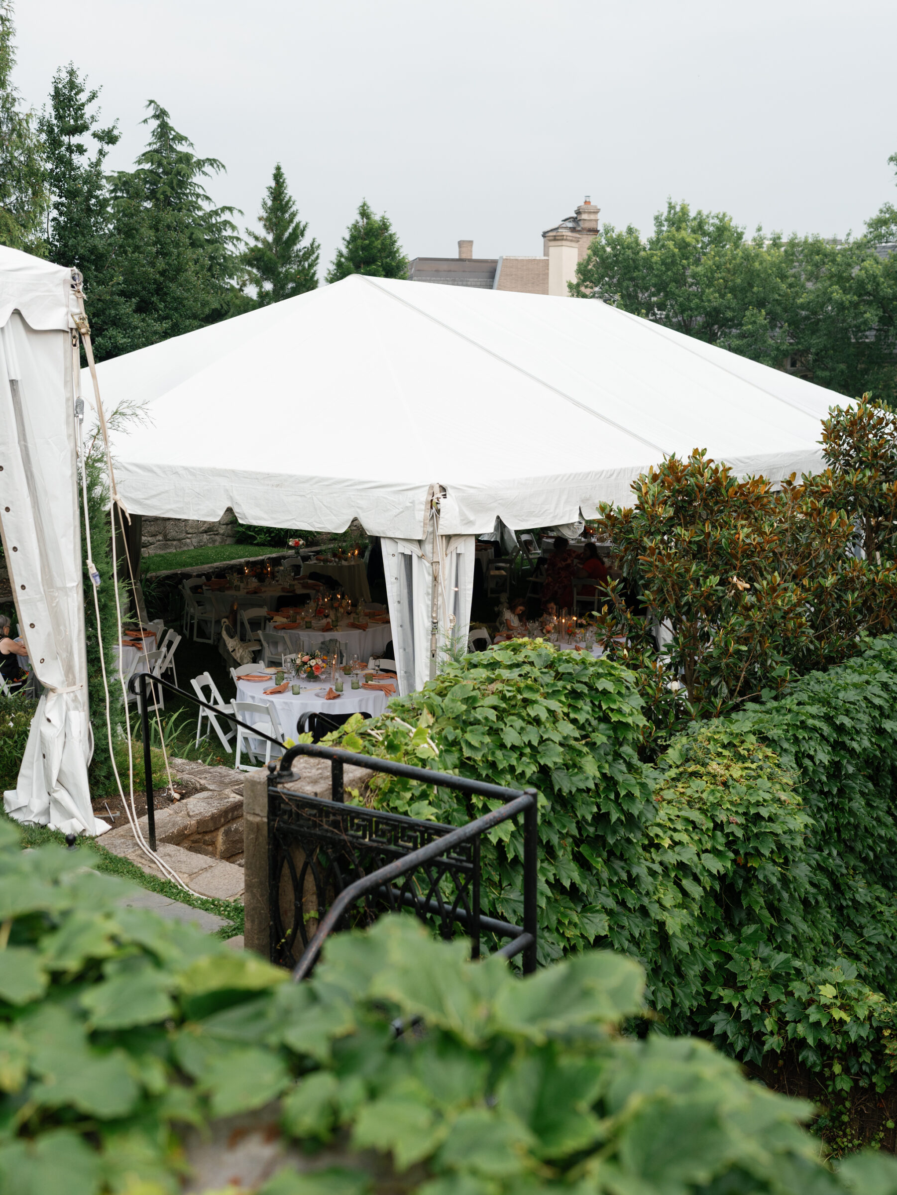 White reception tent set on the lawn of the Woodrow Wilson House Wedding venue in Washington DC, surrounded by greenery and historic architecture.