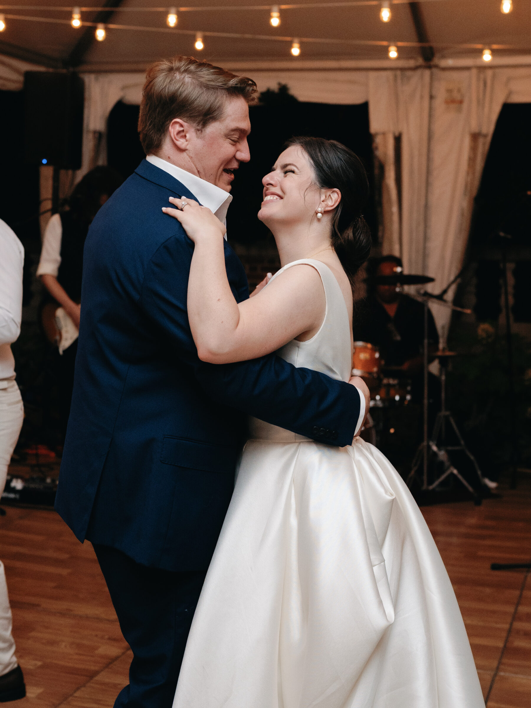 Bride and groom sharing their first dance under string lights at their Woodrow Wilson House wedding in Georgetown DC.