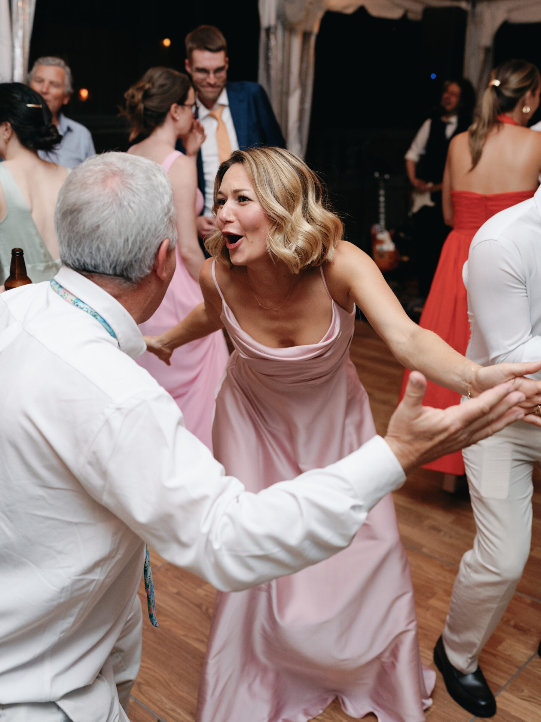 Wedding guests dancing and laughing together on the dance floor during a lively reception at Woodrow Wilson House in Georgetown DC.