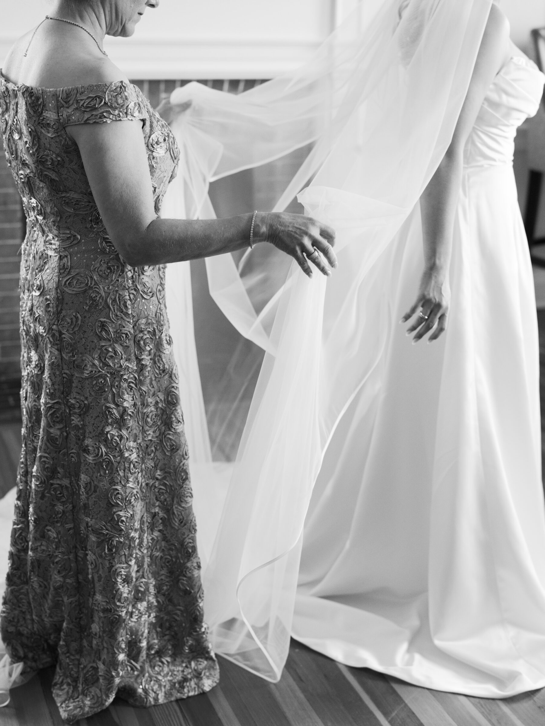 Mother arranging the bride’s veil before the ceremony