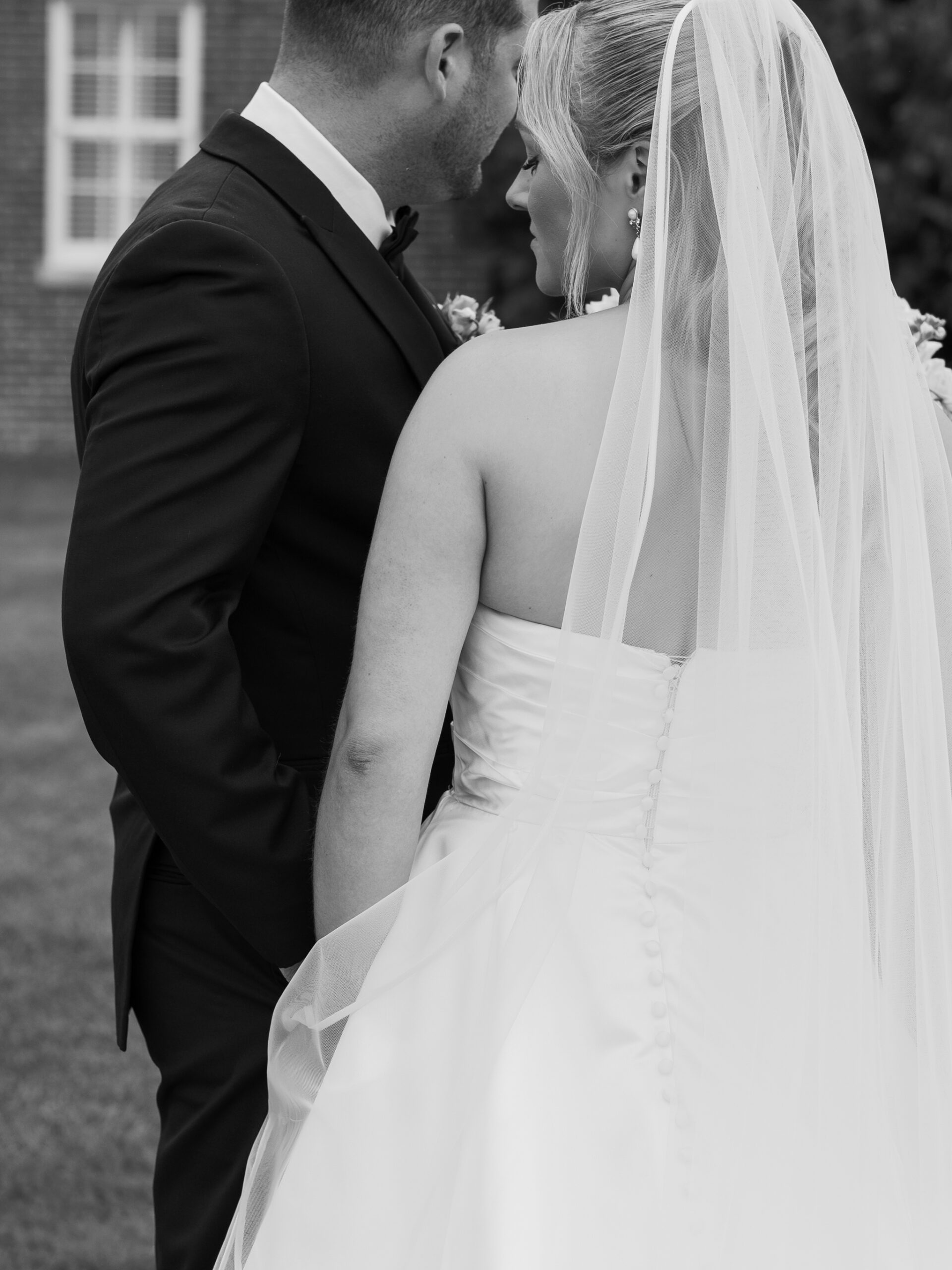 Bride and groom sharing an intimate moment outdoors at Belmont Country Club in Ashburn, VA.