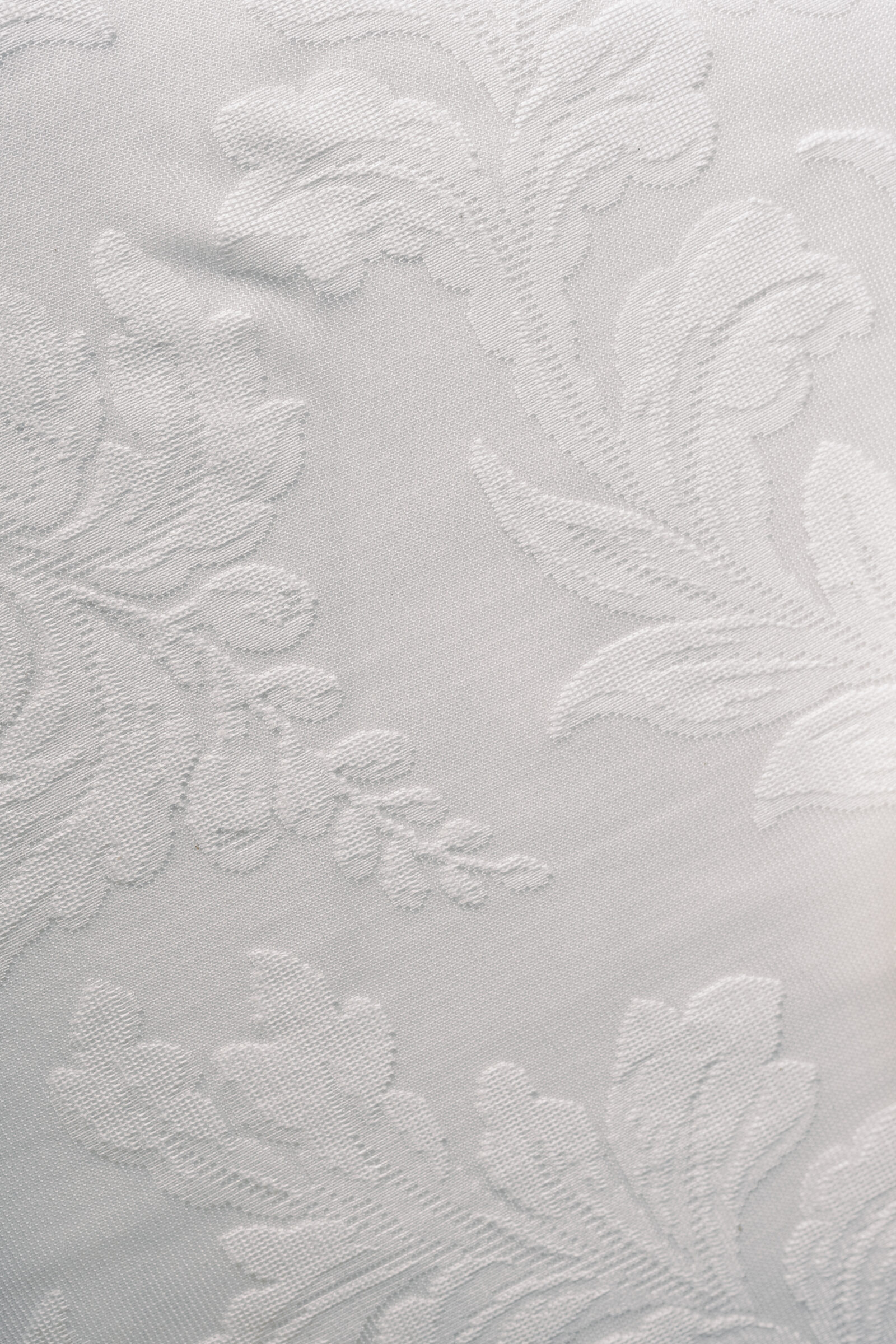 Close-up of white patterned linen tablecloth