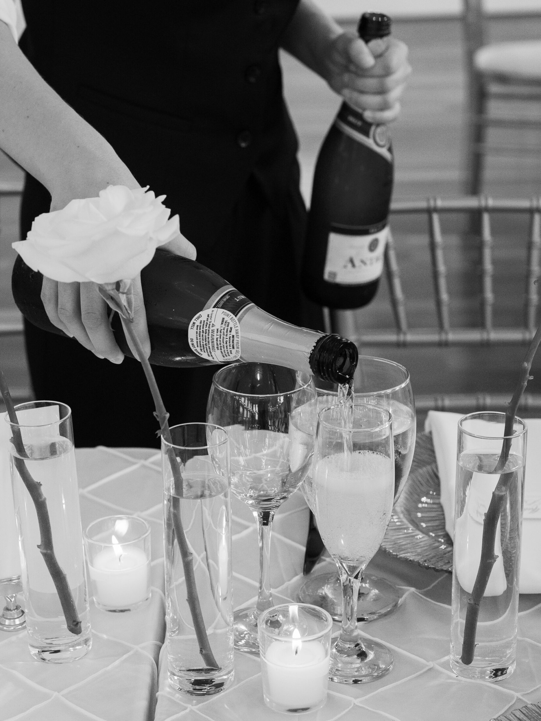 Candid moment of champagne being served among candlelight and florals at a timeless The View at Bluemont Wedding.