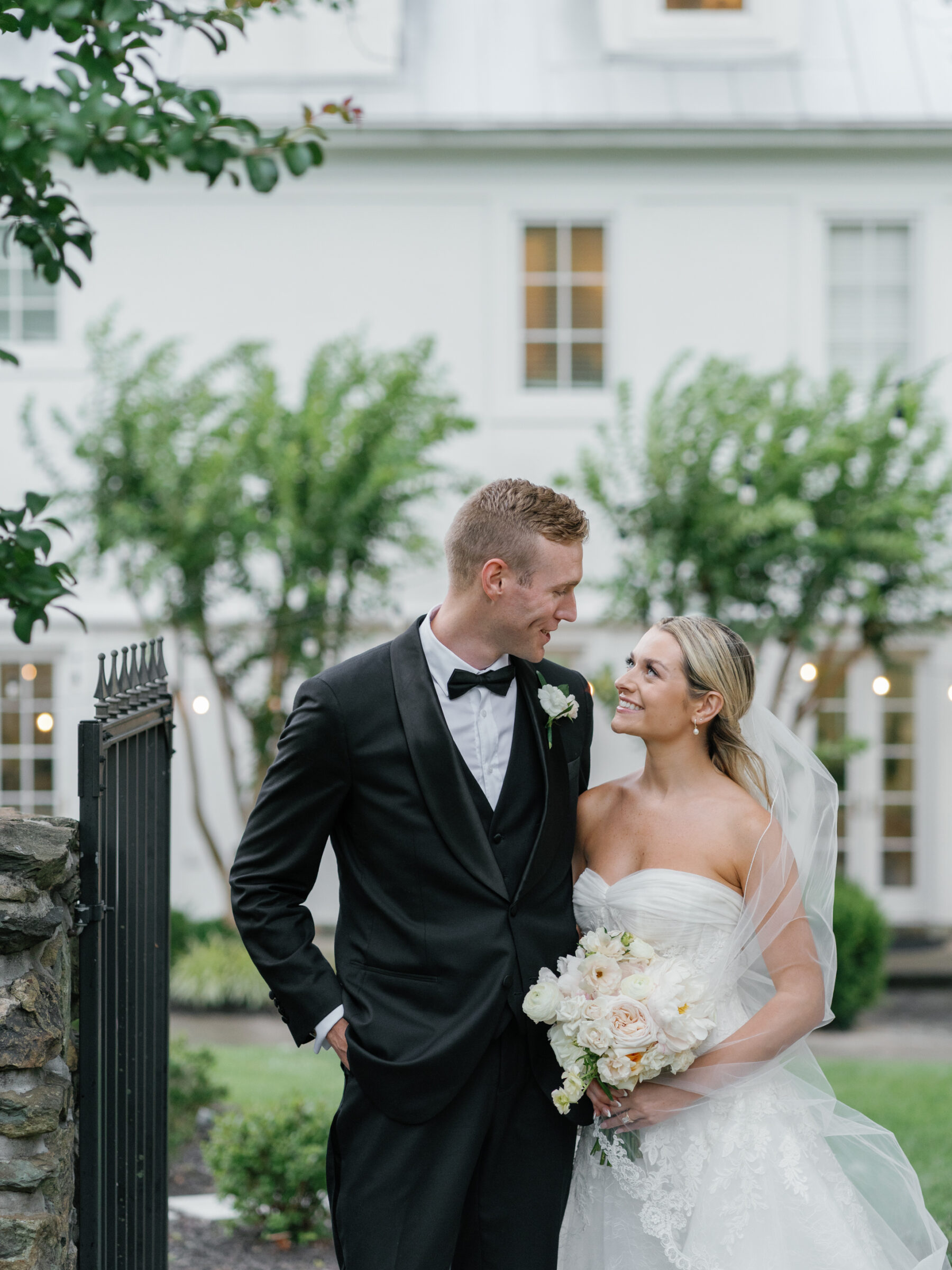 Bride and groom smiling at each other outside The View at Bluemont during their summer wedding in Northern Virginia.