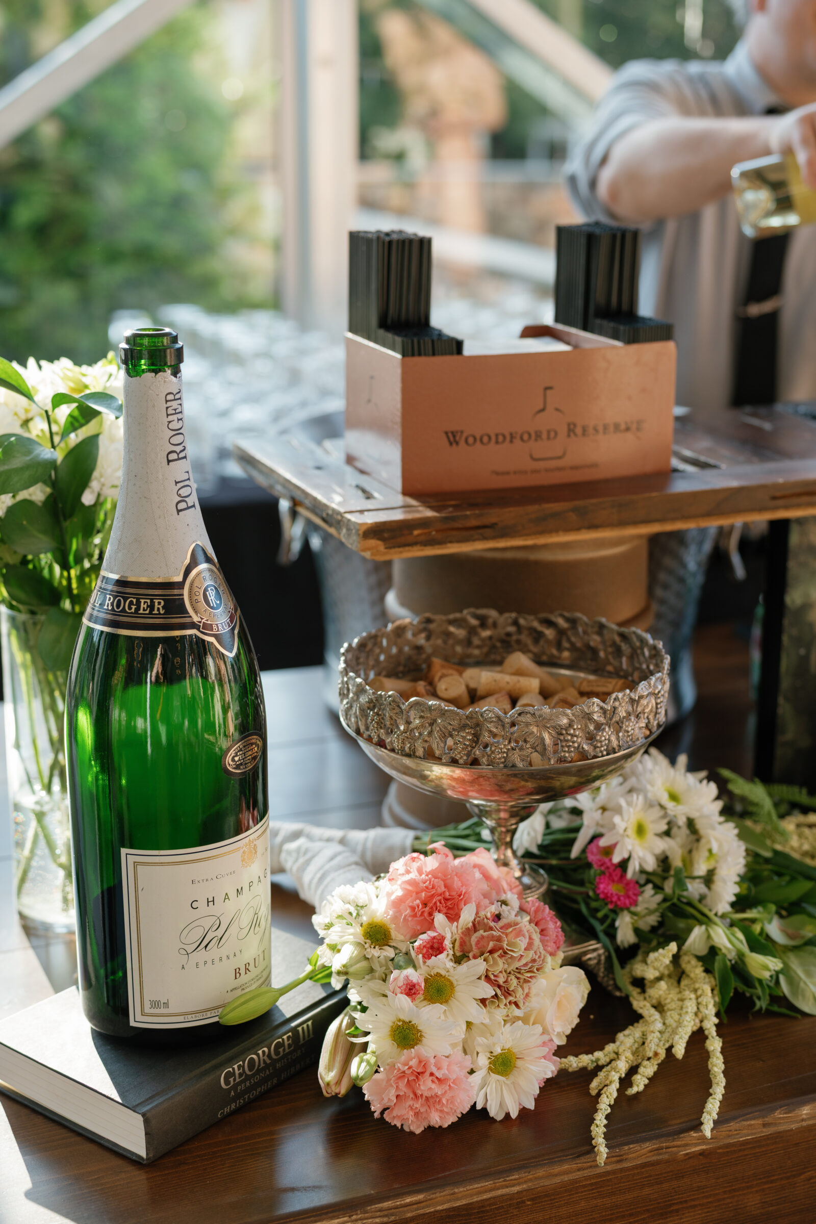 Bar setup at a Richmond VA wedding, featuring a Pol Roger champagne bottle, fresh florals, and Woodford Reserve display.