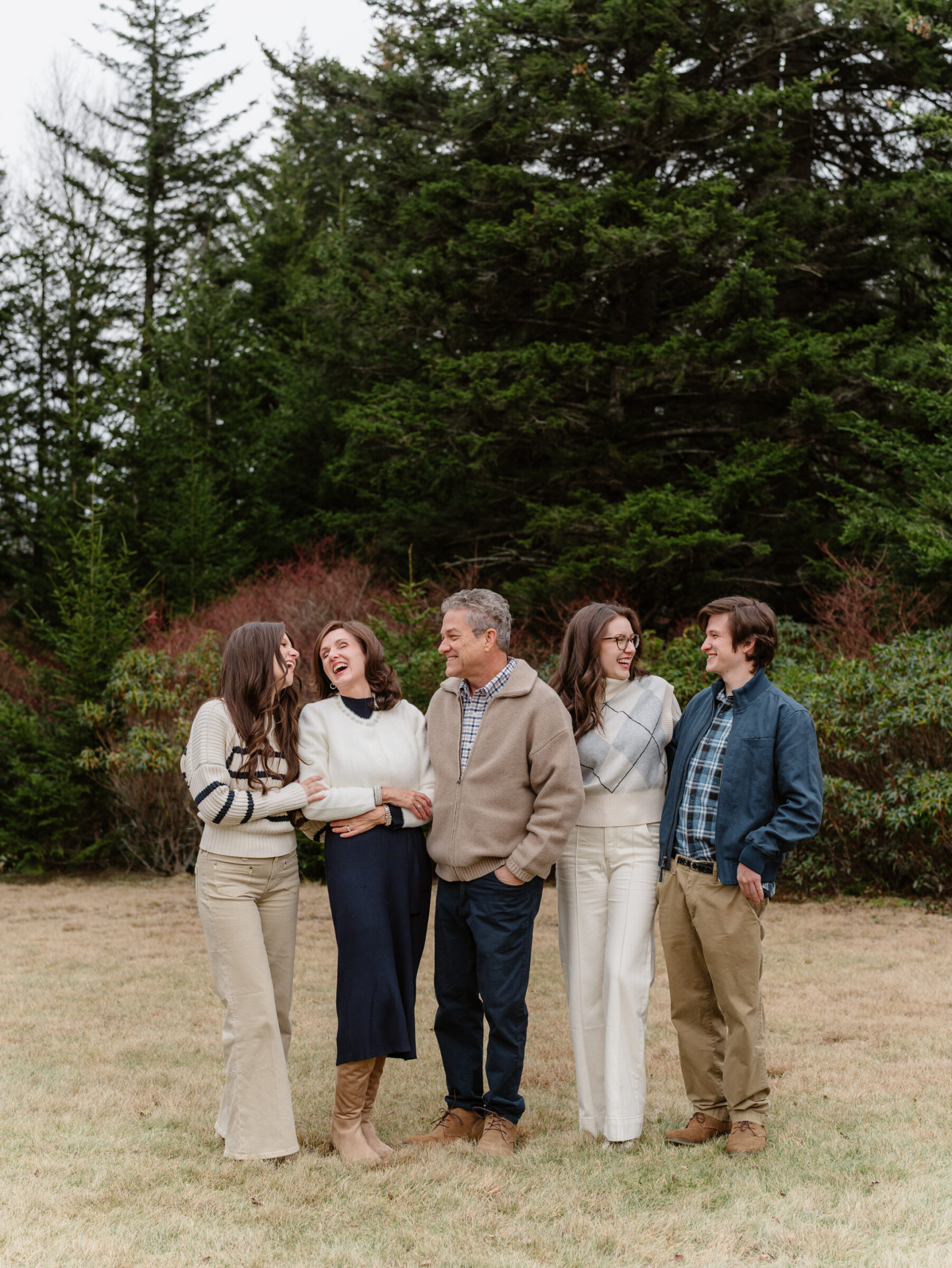 Family laughing together during a late fall family photo session at Grayson Highlands State Park in Southwest Virginia
