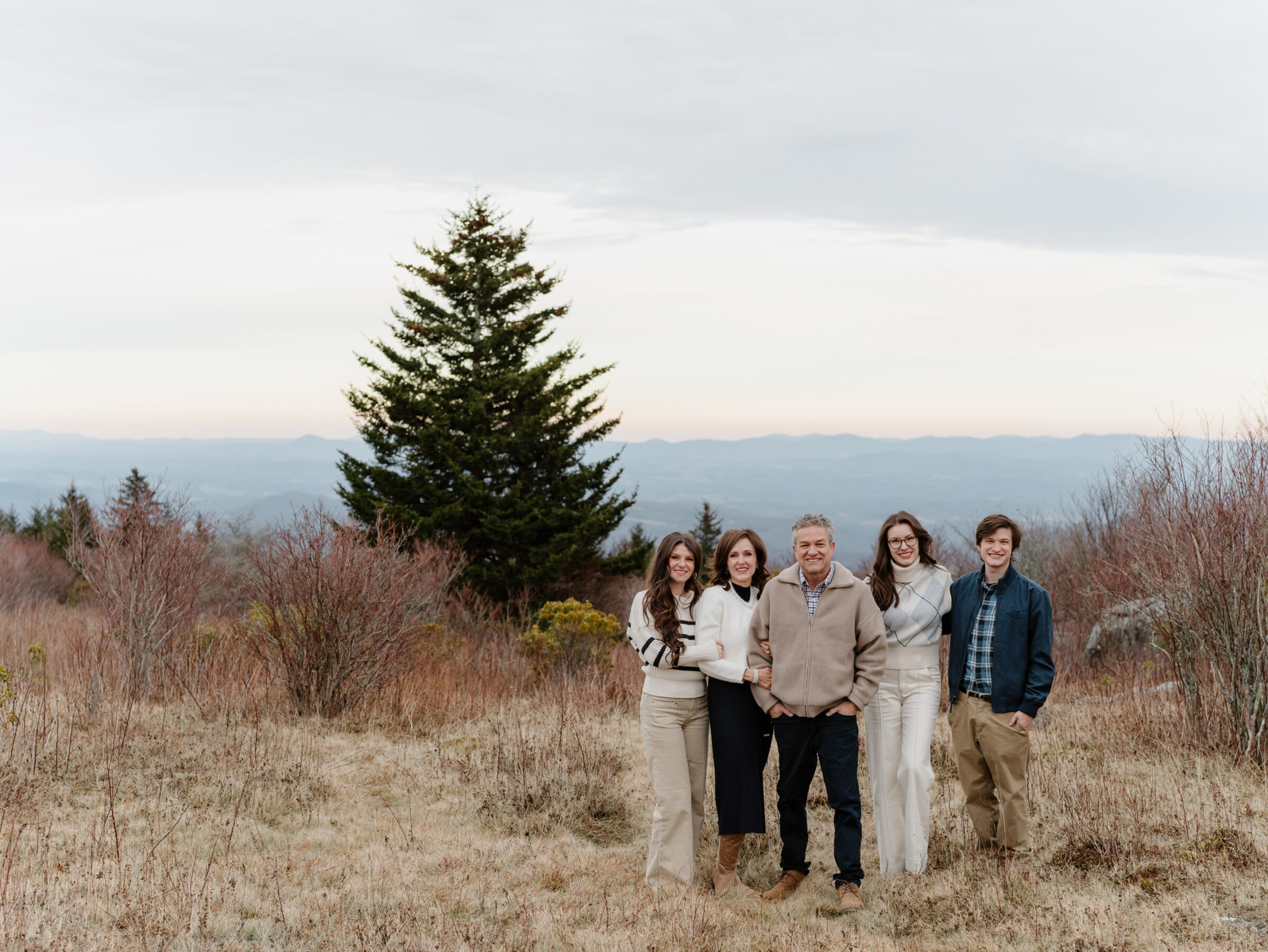 Family standing together at Massie’s Gap during a late fall family photo session at Grayson Highlands State Park in Southwest Virginia