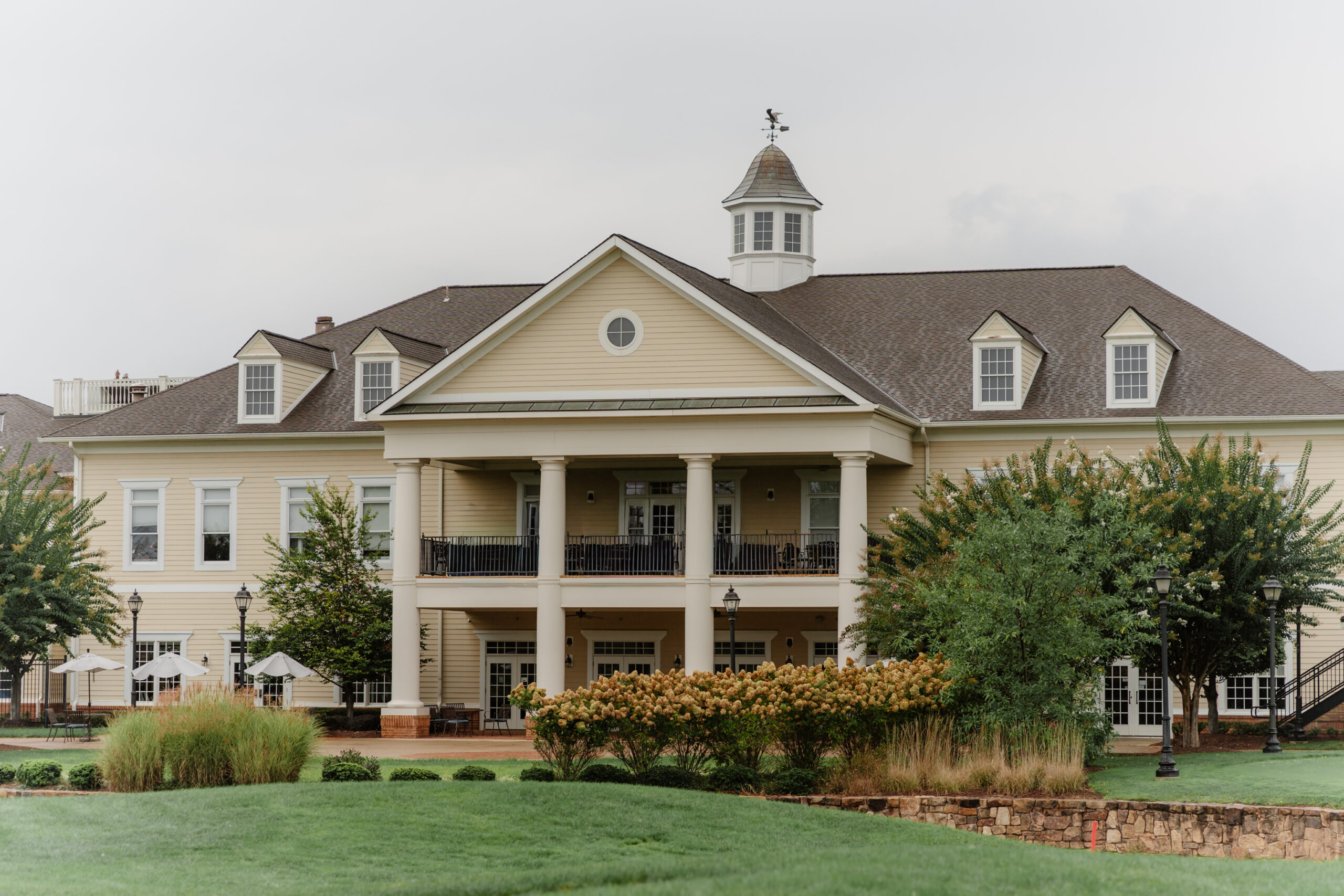 Front exterior of Regency at Dominion Valley wedding venue in Haymarket VA with classic clubhouse architecture