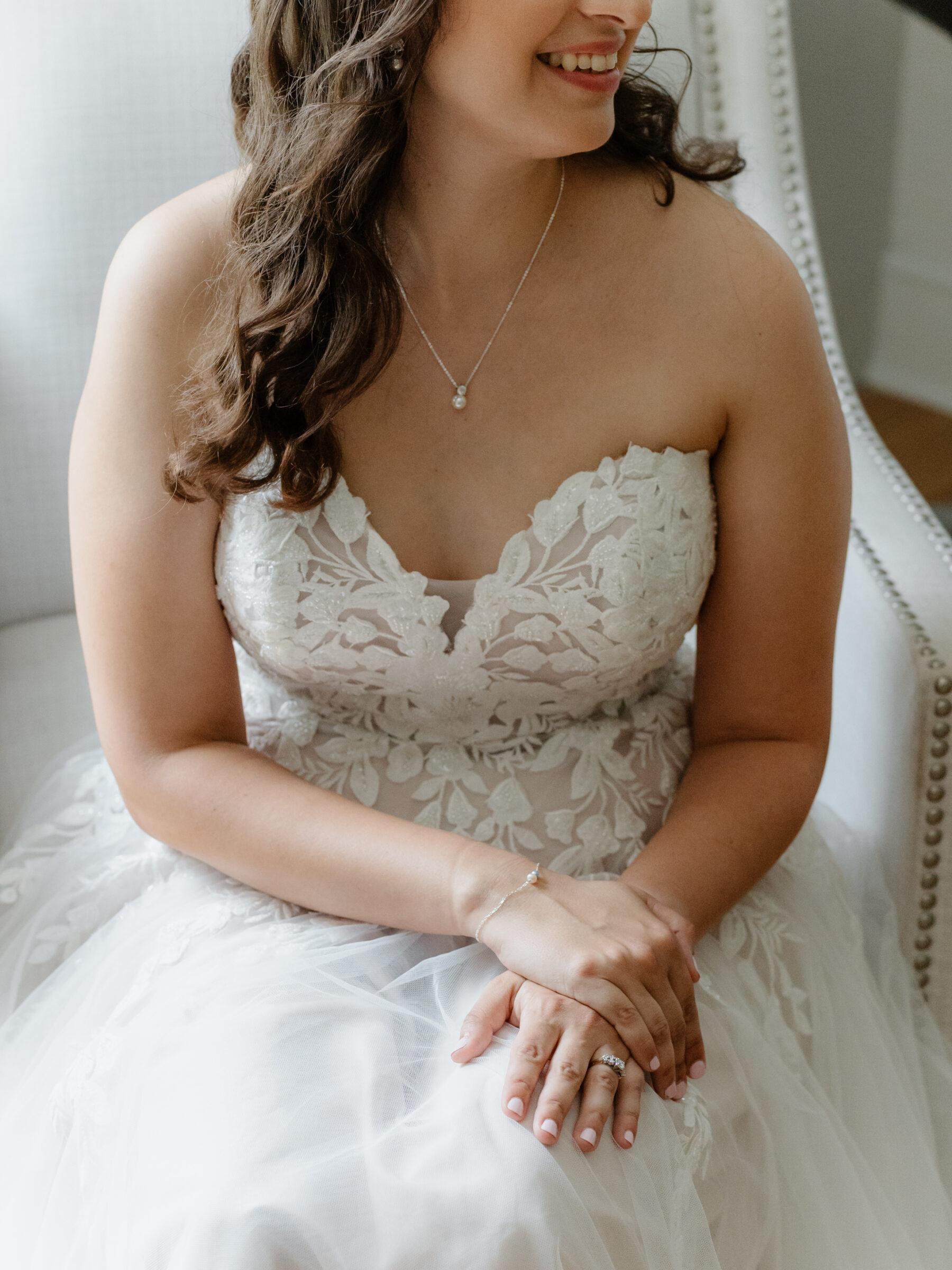 Bride wearing a lace wedding dress and jewelry