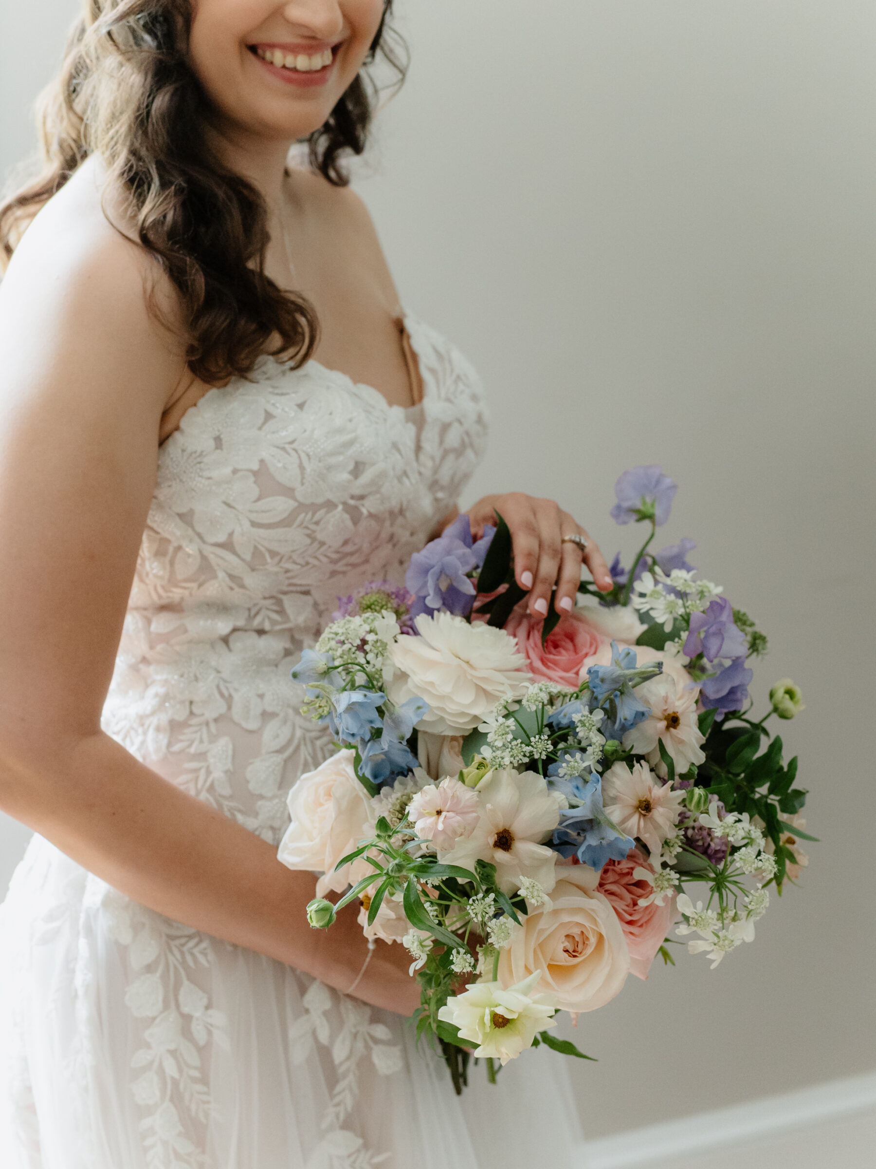 Bride holding a pastel wedding bouquet